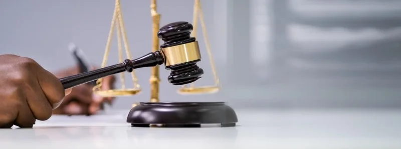 Close-up Of A Judge Hands Writing On Document