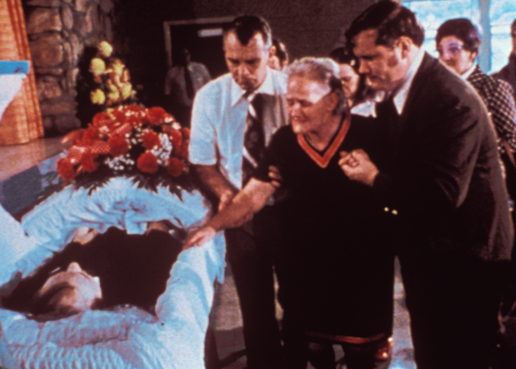 Mourners at a murdered coal miner's funeral (above). Barbara Kopple examining 16 mm film (below). Photo courtesy of Cabin Creek Films.