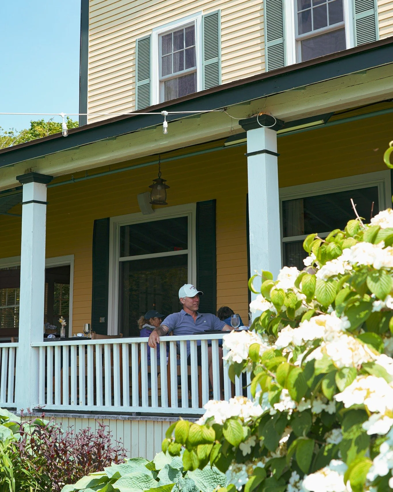 The porch makes a perfect stop after a round of golf &mdash; a cool drink in hand, sea breeze drifting by, and the island moving at its own easy pace.