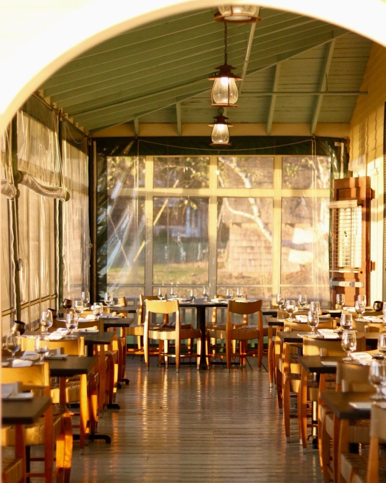 When the porch turns to gold and the first plates arrive, dinner feels like part of the sunset &mdash; thoughtful, seasonal cooking in its best light.