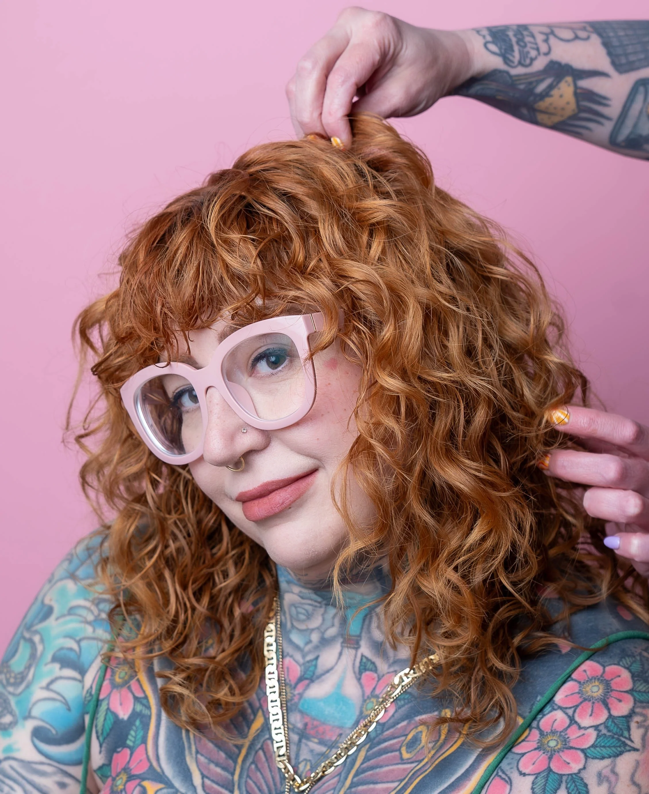 Client with curly copper ginger hair and bangs, colored by Lizzie at Soon Beauty Lab Fort Greene in Brooklyn