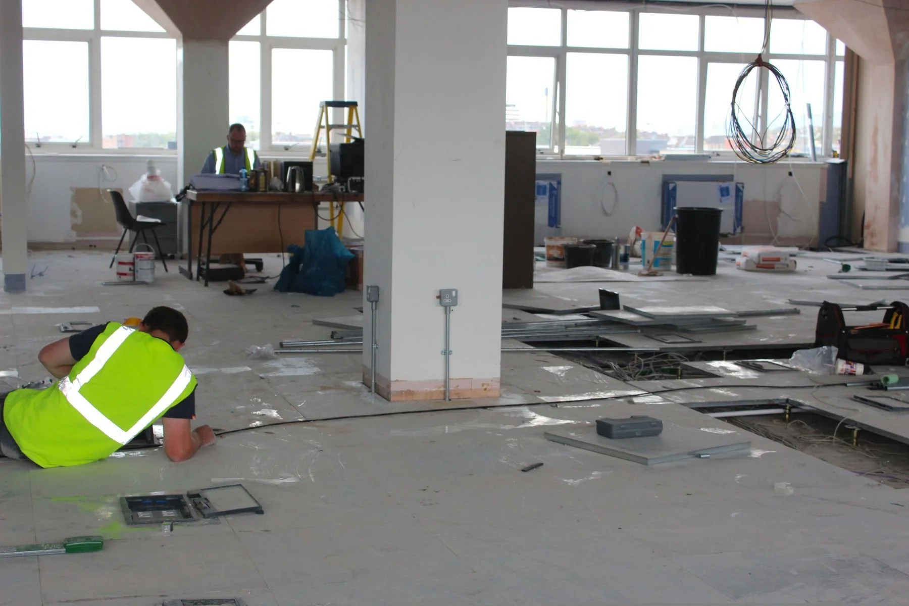 Technician installing low voltage cabling and wiring at a commercial job site in Chicagoland