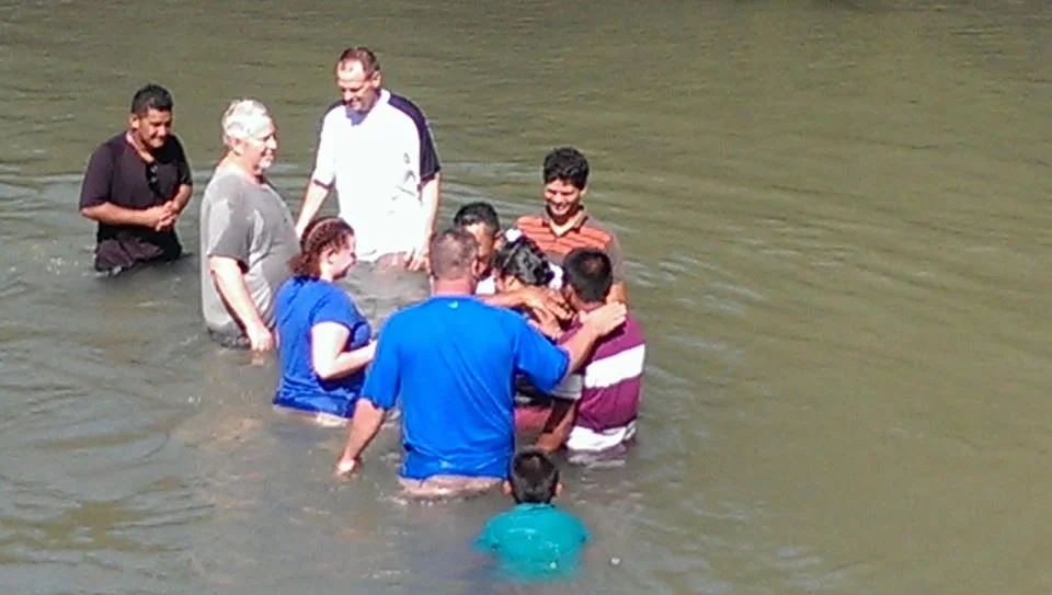 Three discipleship generations, Mateo, our first missionary in the area (red stripe sweater), laying hands over Hermelinda, wife of Pastor Daniel (in white sweater abracing Hermelinda, his wife) and the thin guy in brown sweater, is me.