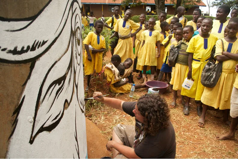 Mural in the process of being painted for the children at a local primary school in Jinja, Uganda on a water tank.