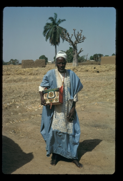 Alhaji Balarabe of Zaria City, addressed there as Sarkin Dukawa (Chief of the Leatherworkers), with one of his products: a satchel containing a copy of the Koran. A comprehensive collection of his leatherwork is in the British Museum.