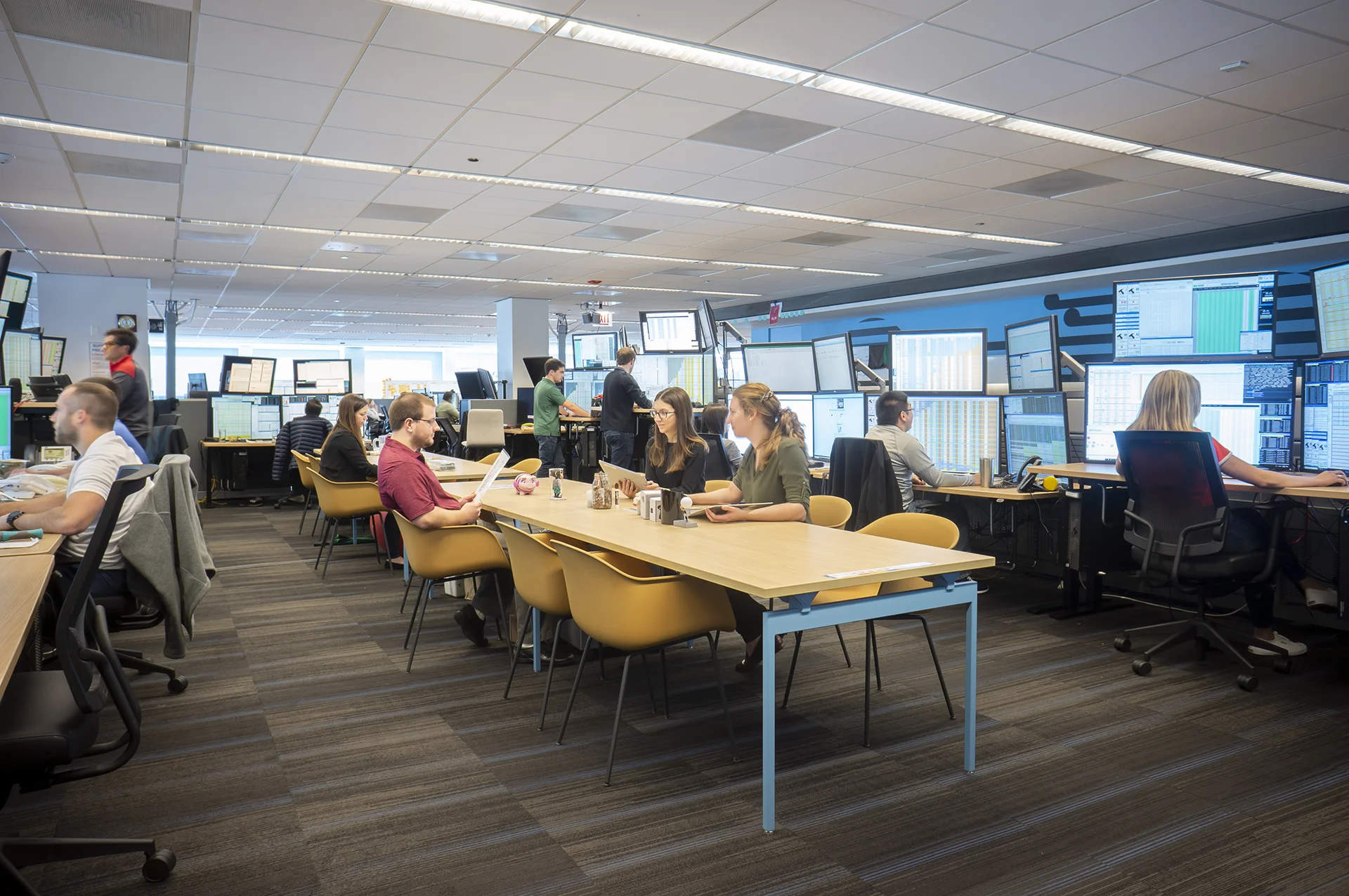 A view of one of the trading pods (or group of desks) in the Belvedere office. Some employees work in tables in the center while others sit at their desks around the perimeter.