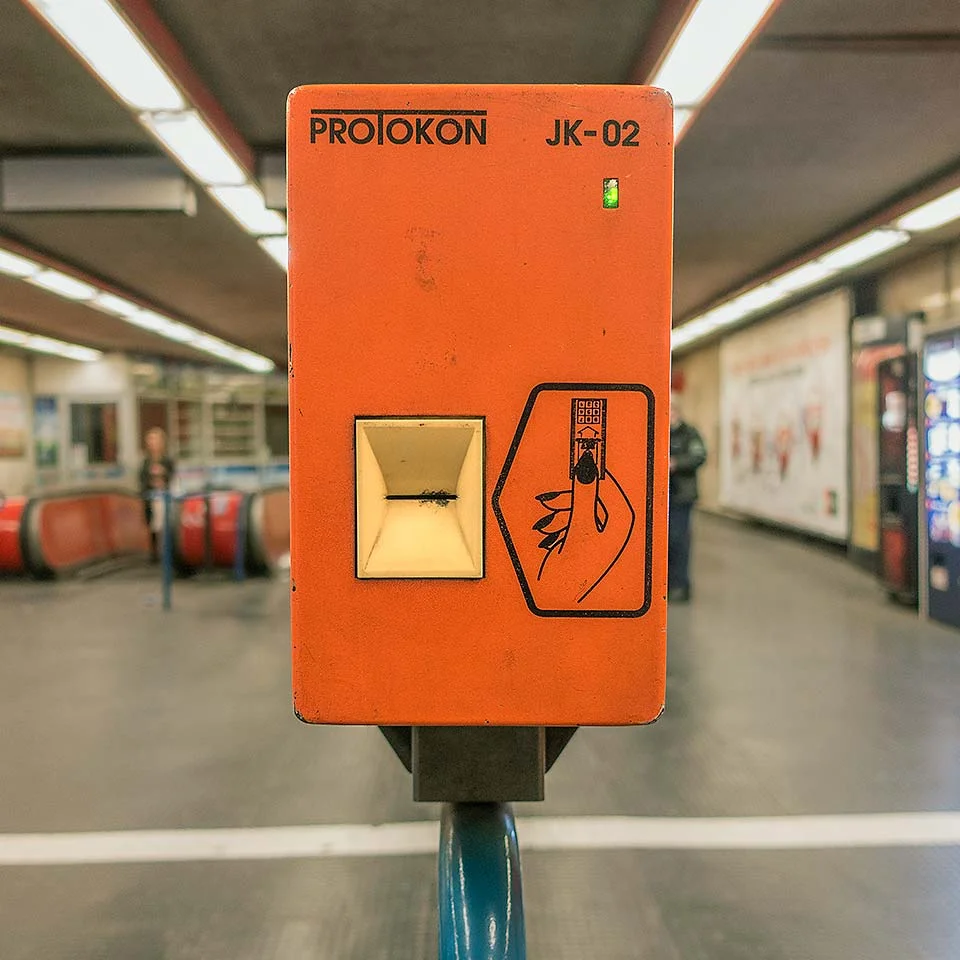 A row of bright orange old-school PROTOKON JK-02s still stand guard at every Budapest Metro 3 entrance to validate single ride tickets with a time and date stamp.