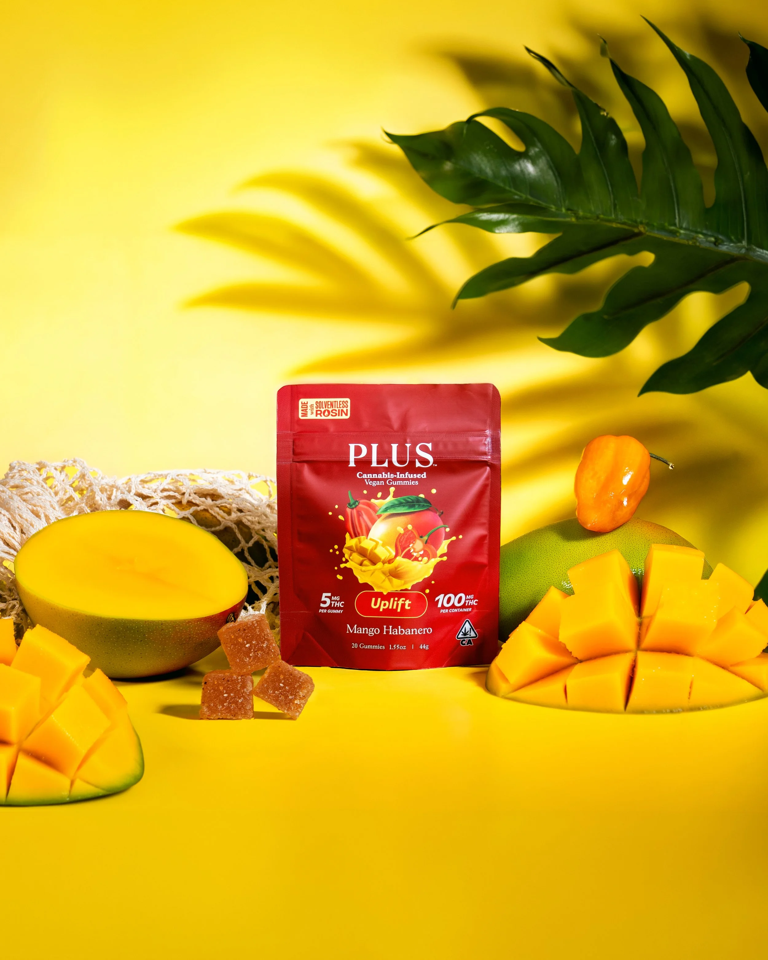 mango habanero gummies pouch. with chilis and cut mango surrounding it