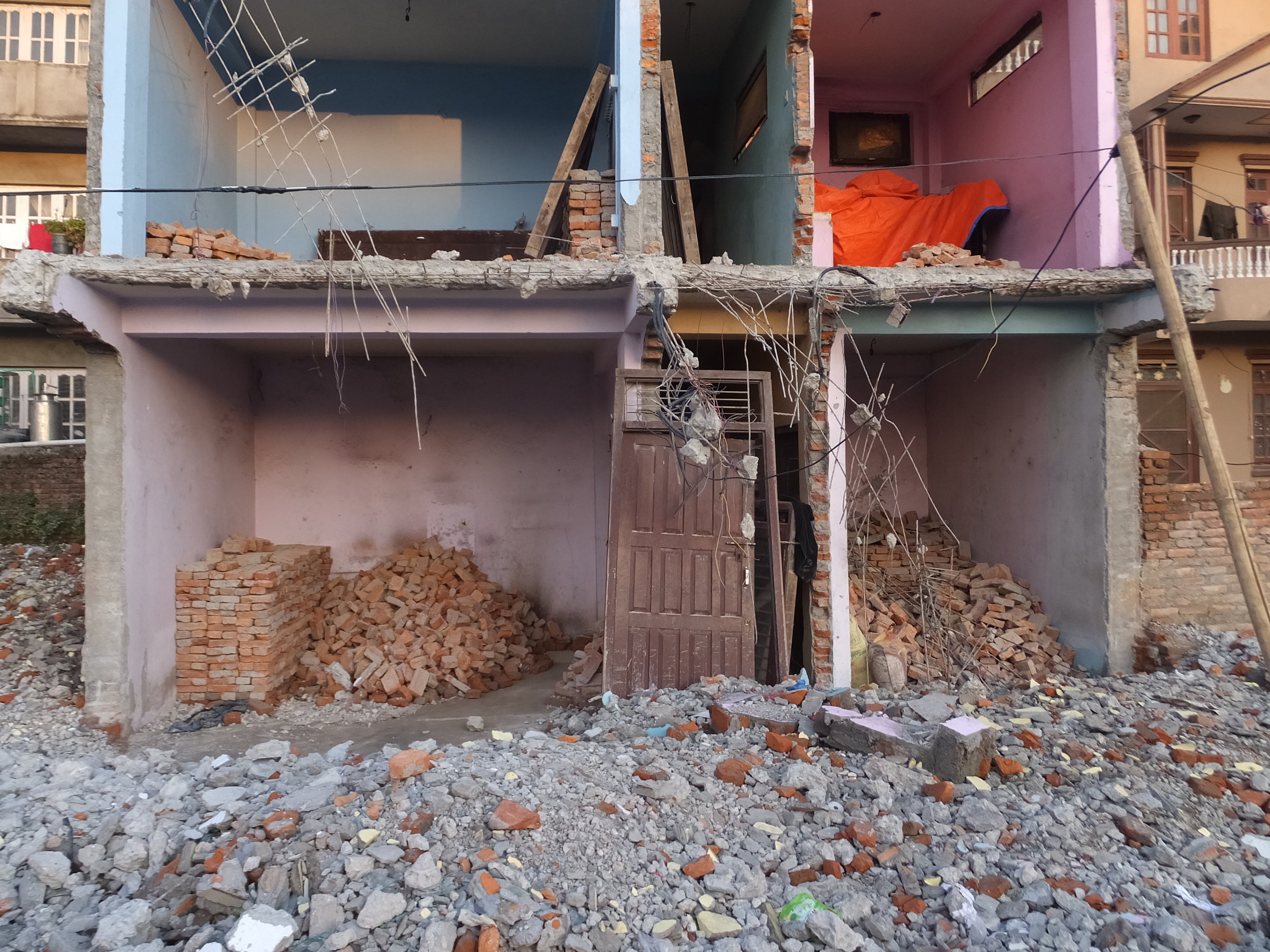 Systematic removal of house fronts for failed city planning.