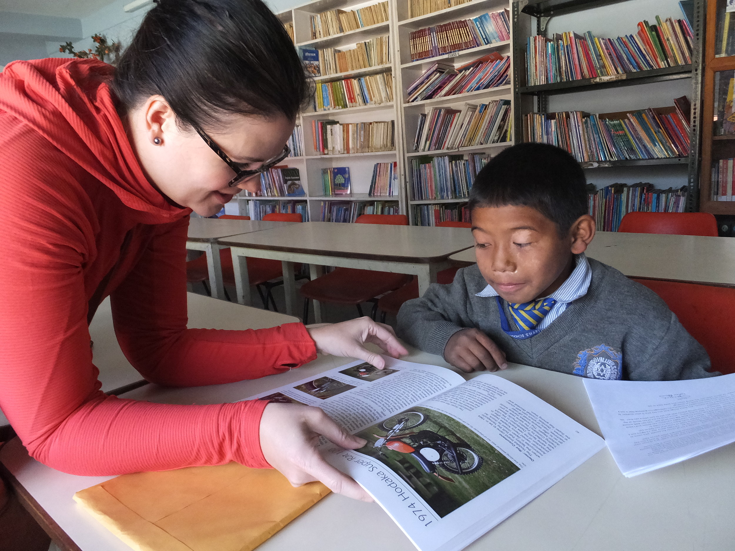 Alexis, Development Director, enjoys reading with one of the children.
