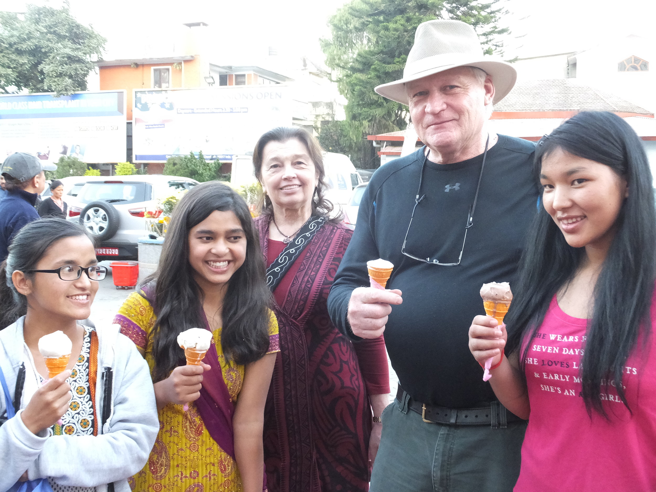 Dr. Sandra Hoffmann, Vice President, and Steve Schirber, child sponsor enjoy a special ice cream delight with the girls!