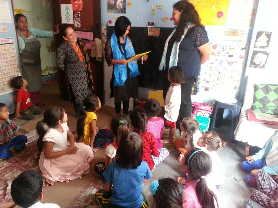 Rogina gets a special gift from the children for her exemplary teaching and service at the Contact Center