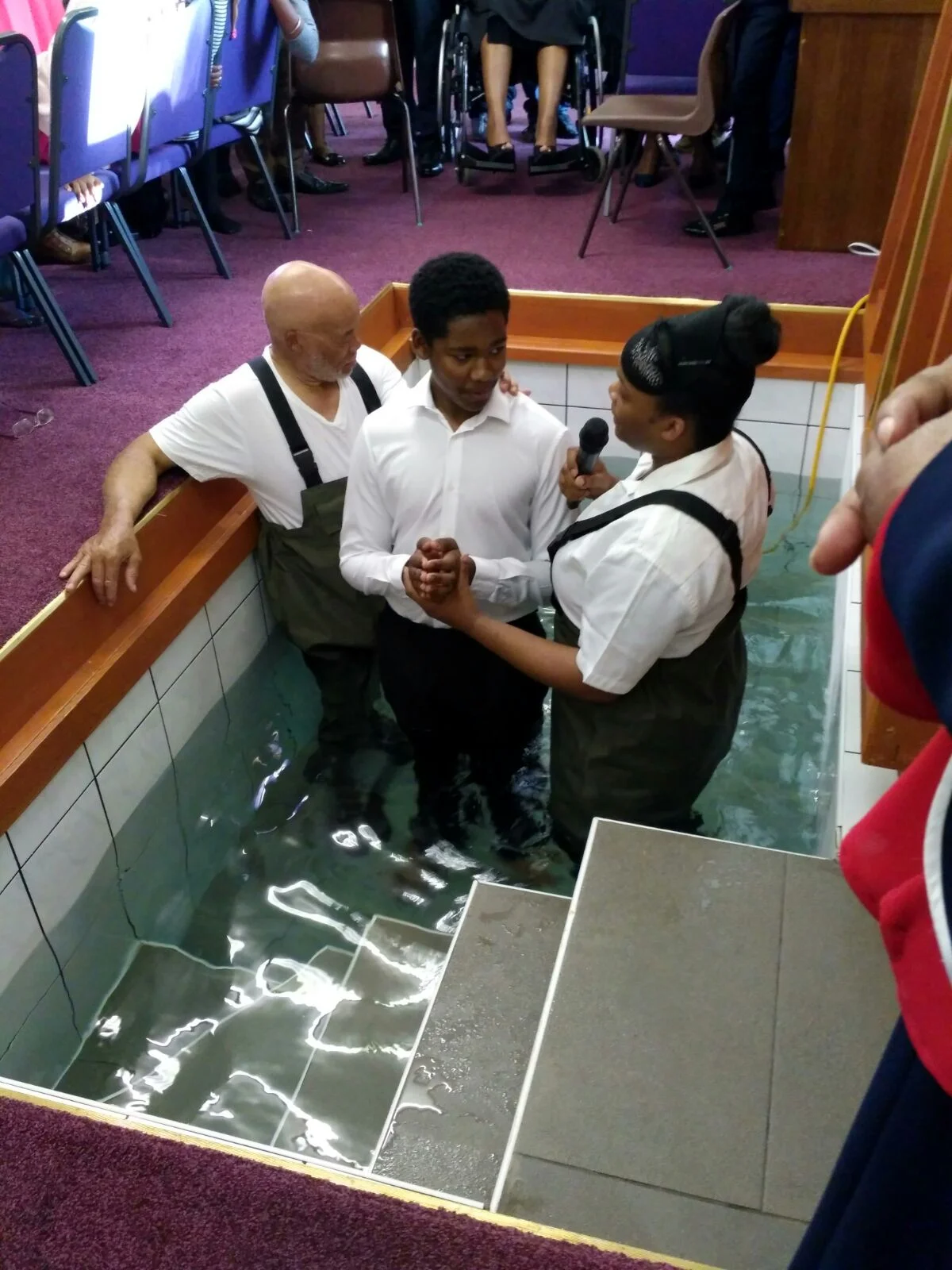 Minister Rebekah Sylva performing a baptism at B.A.C.E.