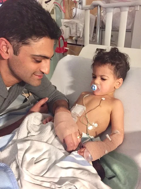 Dad cheering up our survivor following his first surgery.