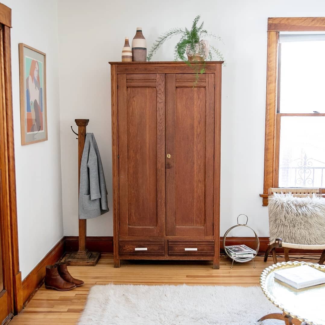 Incorporating antiques, vintage items and family heirlooms into our homes can make a HUGE difference. 
Scroll to see this room BEFORE and AFTER we added an antique armoire, vintage flokati rug, moroccan brass coffee table, Hans Wegner-style woven fol