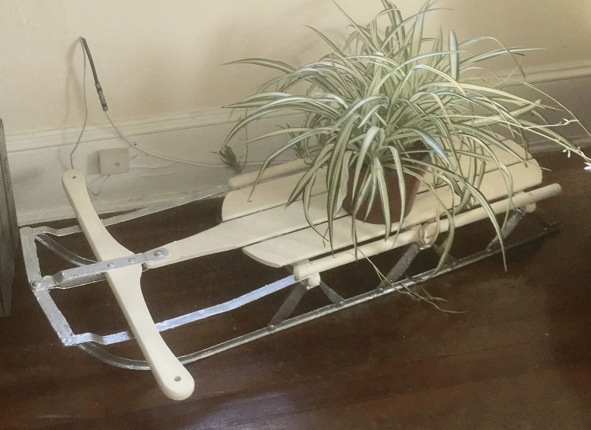 Repurposed and refinished antique wood sled planter