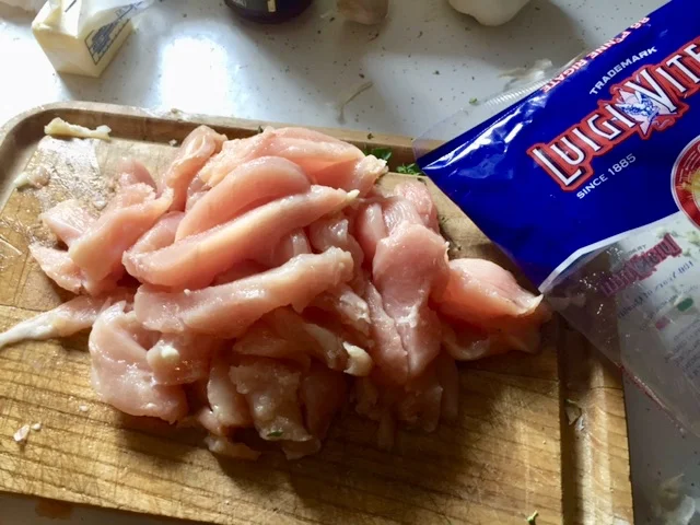 Pasta and Chicken: Add 2 tbs of butter to a skillet with diced garlic cloves and diced onions and simmer until clear. While onions and garlic are cooking down, cut chicken breasts into strips. Add Chicken to skillet with onions and garlic and put a lid on so they cook as through as possible.