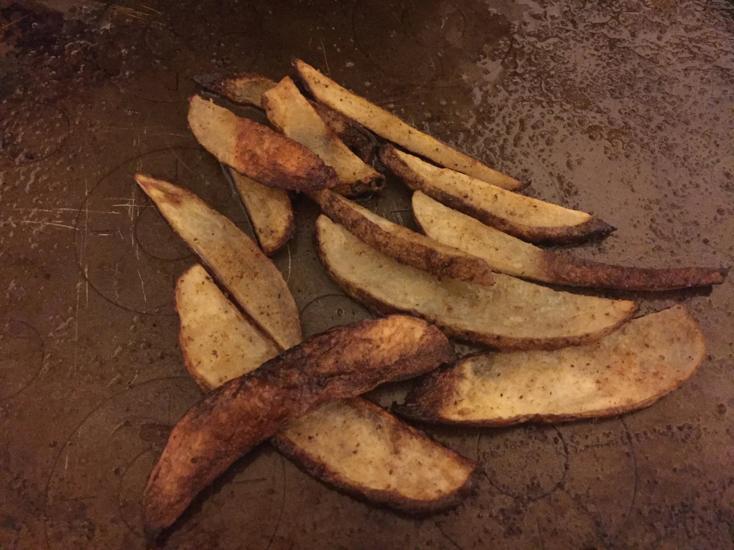 Ingredients Potato (medium) for every individual you're serving olive oil (2- 3 tbs per sheet pan) Old Bay Seasoning Plan of attack Preheat the oven to 390 degrees Slice the potato into thin wedges by cutting the potato down the middle lengthwise and then using a paring knife to make very thin wedges from both sides. Put the wedges (slim) on the sheet tray. *the thinner the slices, the crispier they'll get and the quicker they'll cook* Toss your potatoes in olive oil, using your hands to evenly coat every slice with olive oil. Cover the potato slices liberally with Old Bay Seasoning. Put potatoes in the oven for 9-13 minutes, checking regularly and using a spatula to make sure they cook evenly. My Comments: This is as close as ya'll can possibly get to a guilt free fry. It is in its bones, a potato, with minimal oil, baked into crispiness. We deserve abundance and fries just make the journey worthwhile!