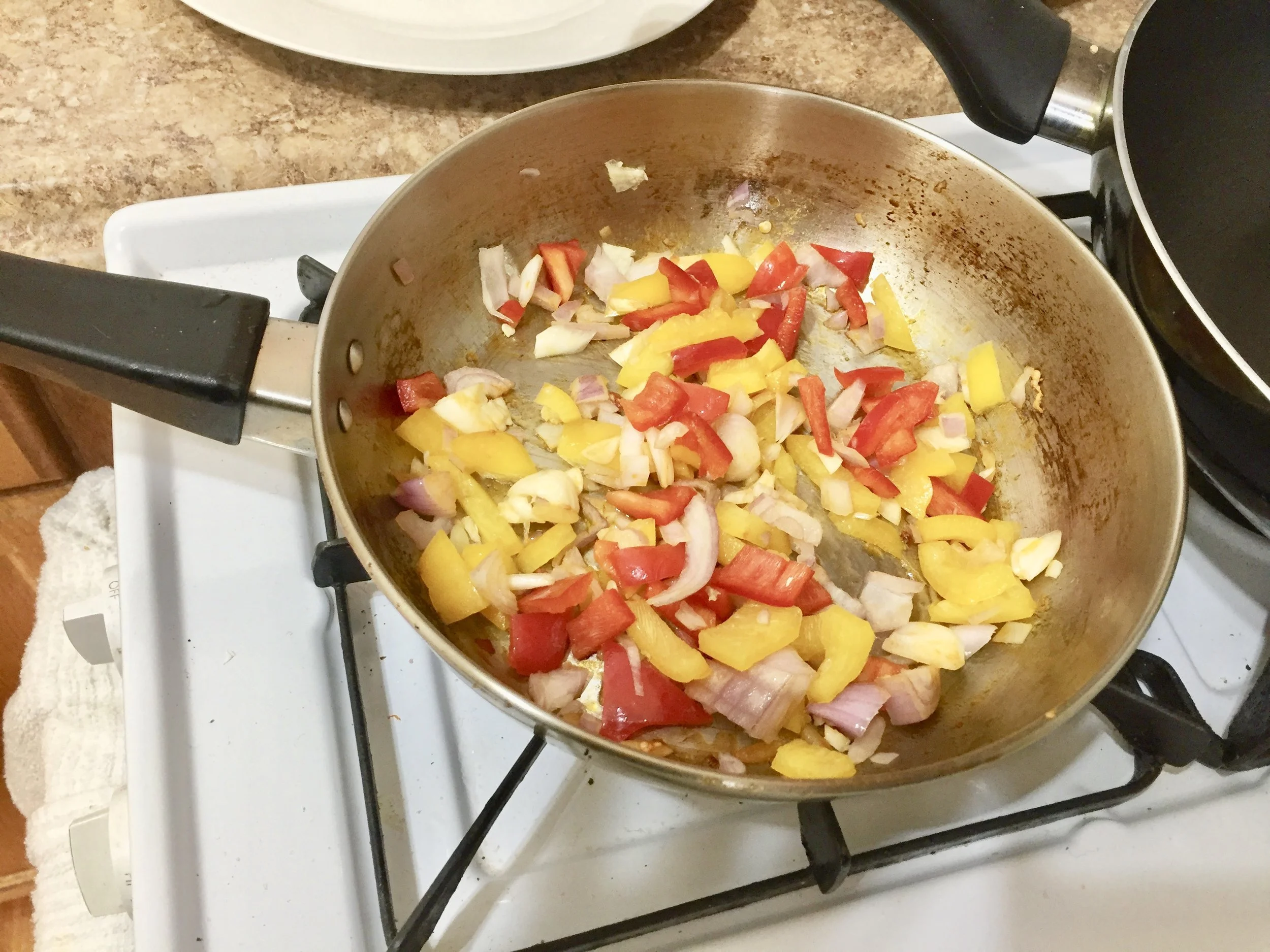 Add the peppers, onions, and garlic to the chorizo drippings, with tbs of olive oil. Cook over medium heat for 5-6 minutes.&nbsp;