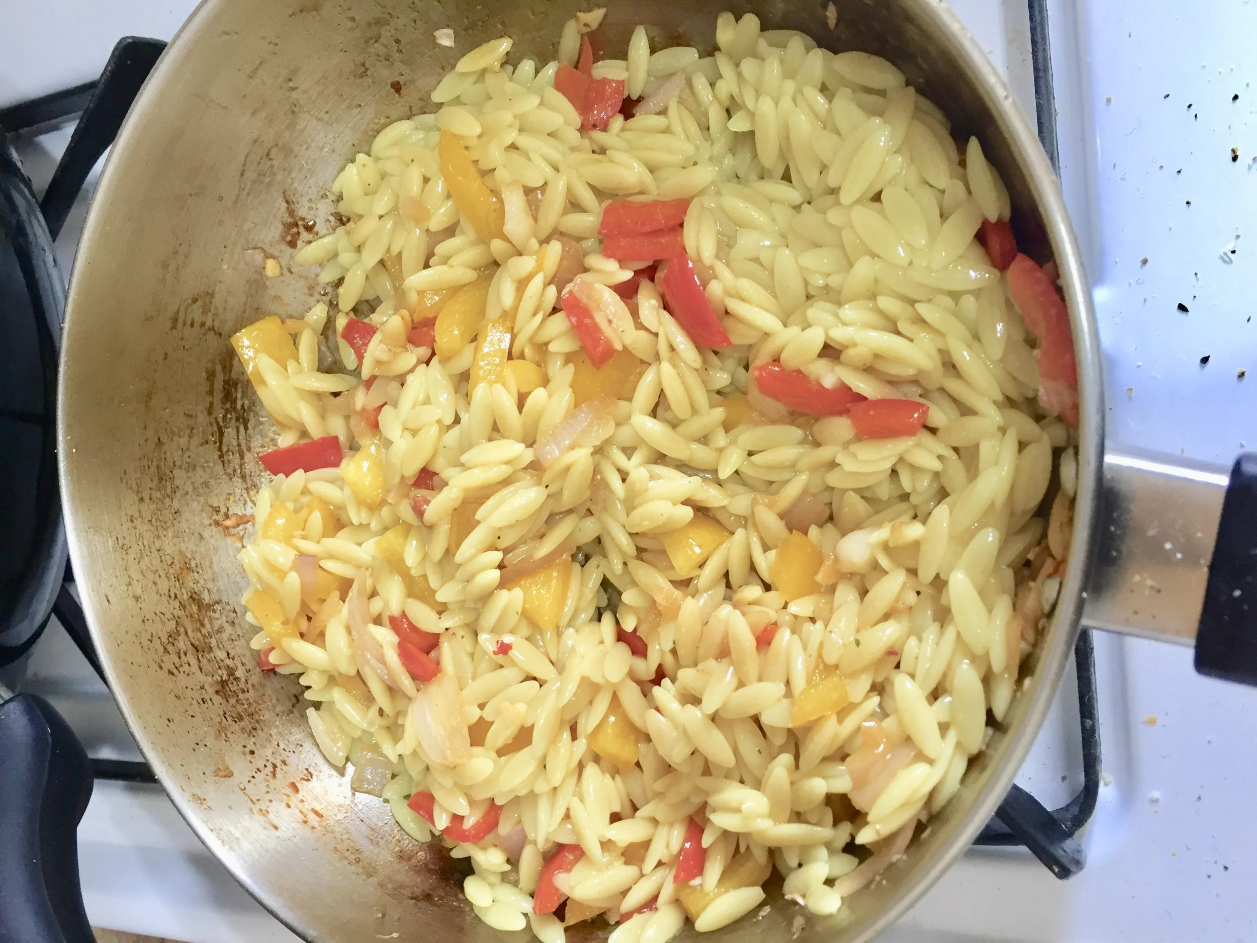 Add the orzo, the chorizo and crumbles of feta to the skillet with the vegetables. Mix throughly.
