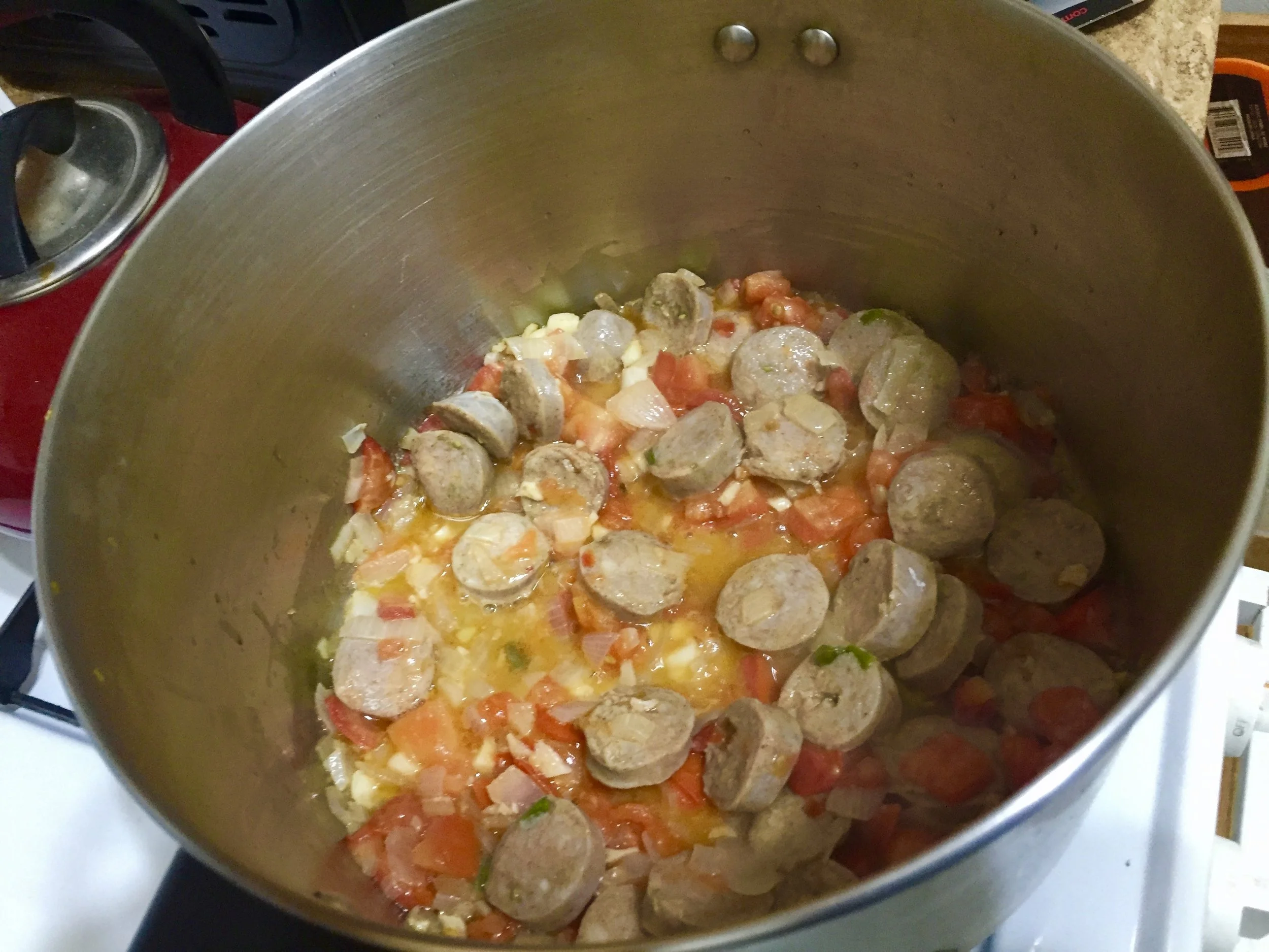 Coin the chicken sausages and add them to the stockpot. *You can also cut a slit down the links and use more sausages, but by coining the 3 I had in the house the sausage covered more ground portion wise.