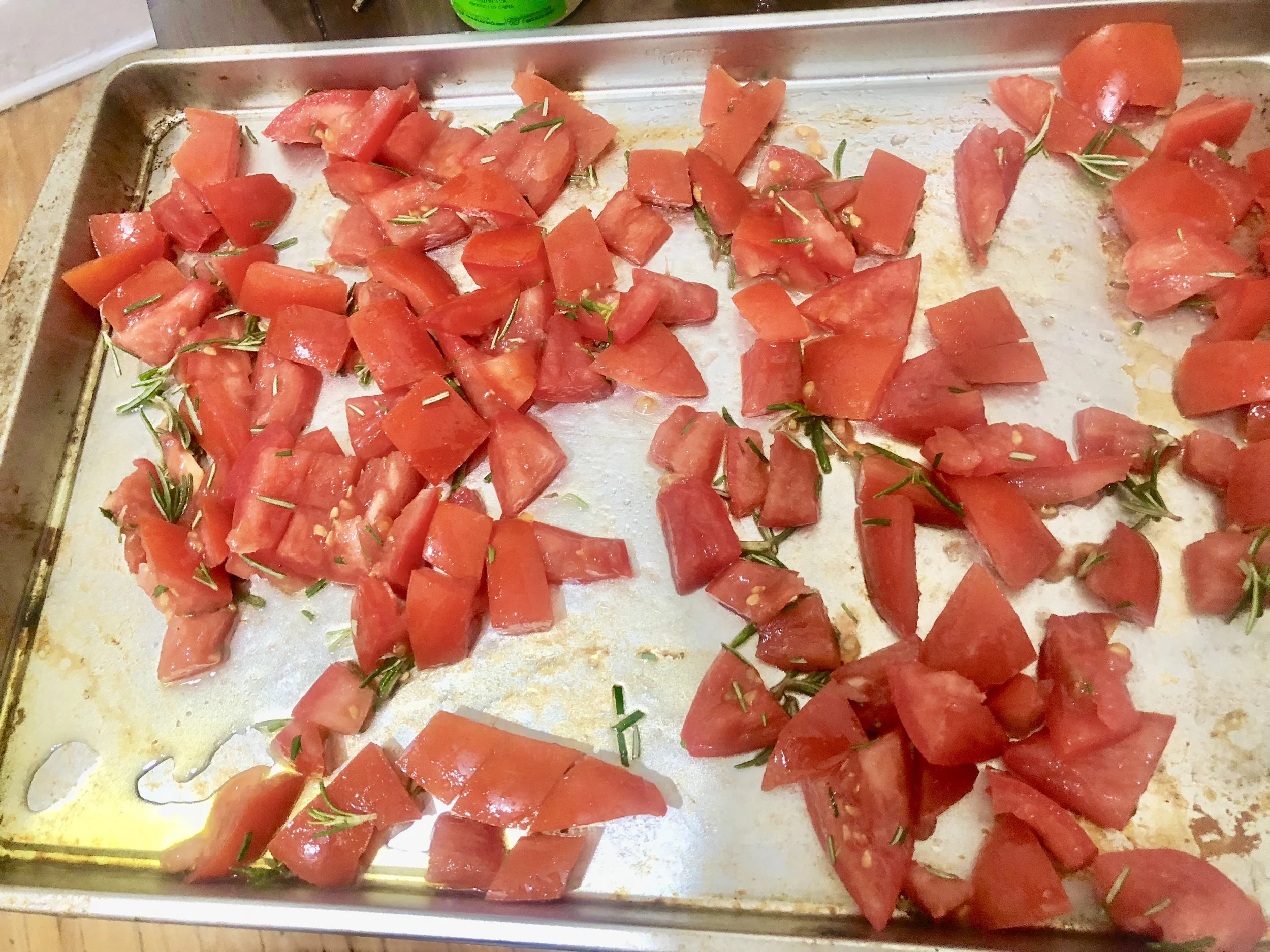 Toss the tomatoes and rosemary with olive oil and season with ground salt and pepper. Put on an oiled cookie sheet and put in the oven for 25-30 minutes.