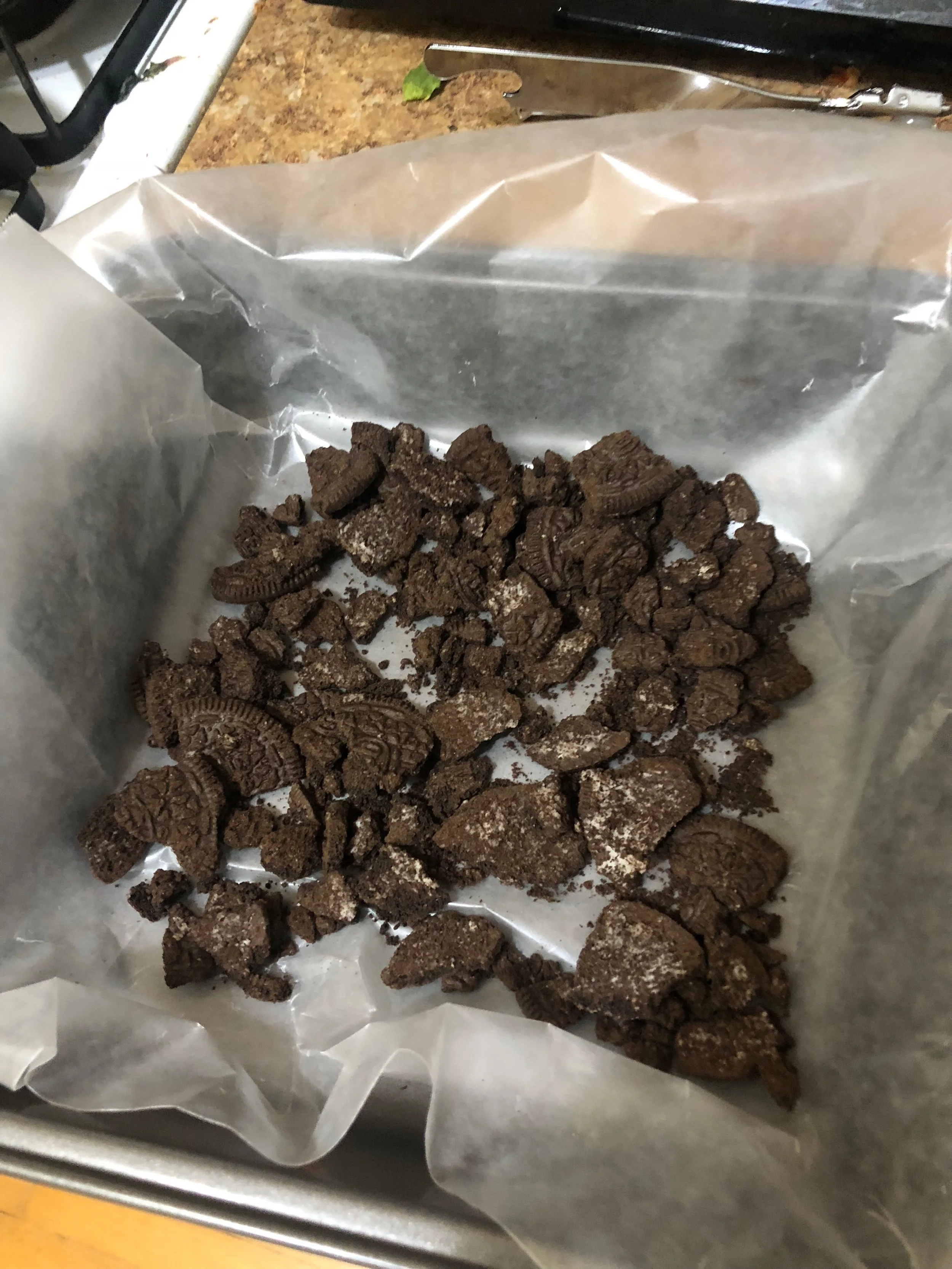 Line a 9x9 baking dish with wax paper (or parchment paper). Using a measured hand cover the bottom of the pan with crushed cookies, being careful to reserve a serious portion to mix into the fudge.
