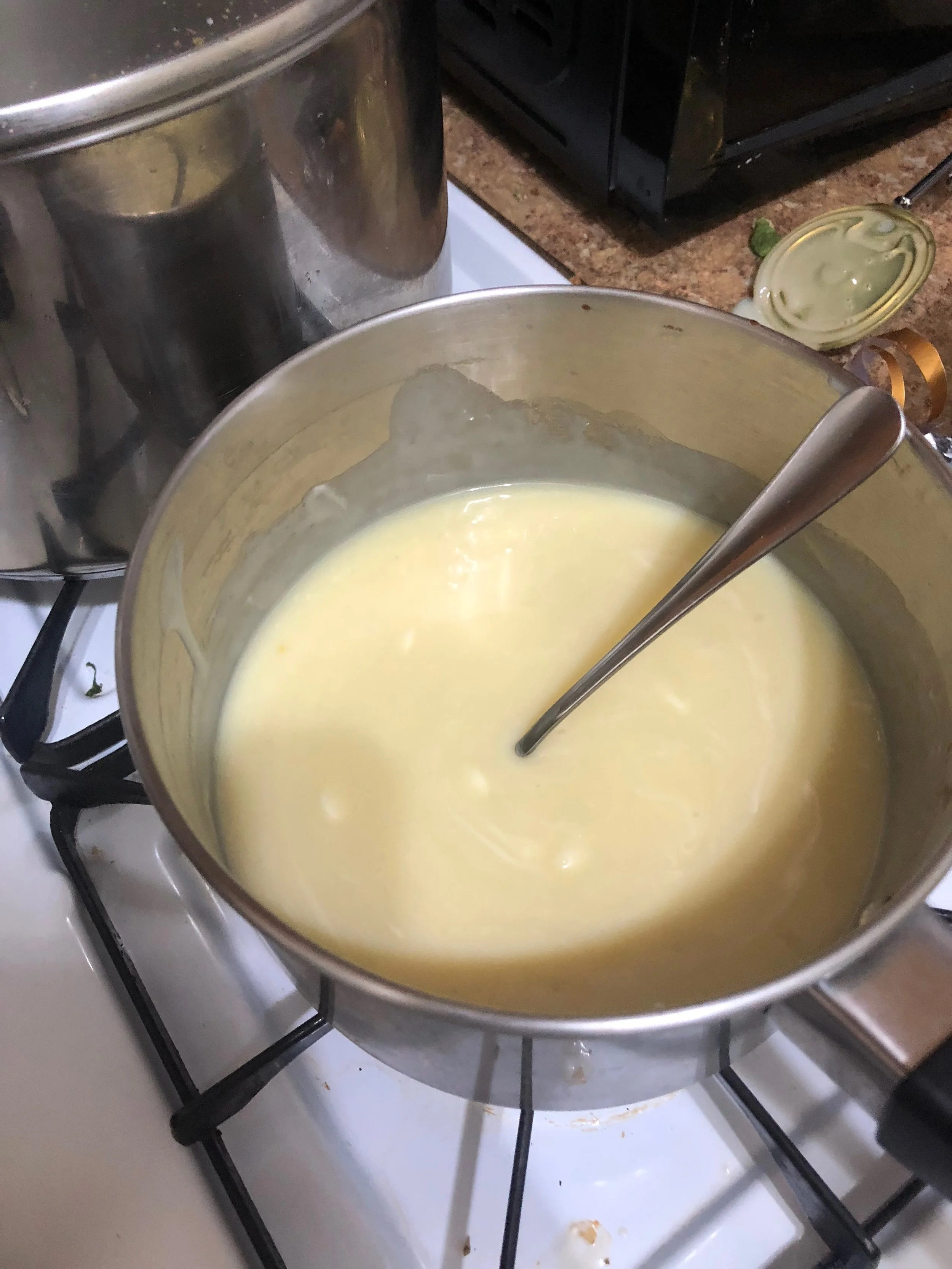 Add the an of condensed milk, 2-3 cups of white chocolate chips, 2-tbls of butter and a sprinkling of salt to medium saucepan over low heat. Add the chips in batches, making sure to continuously stir the mixture so the bottom of the pan does not burn and the chips, butter and milk are all integrated. When everything is mixed, you have the option of adding the vanilla.