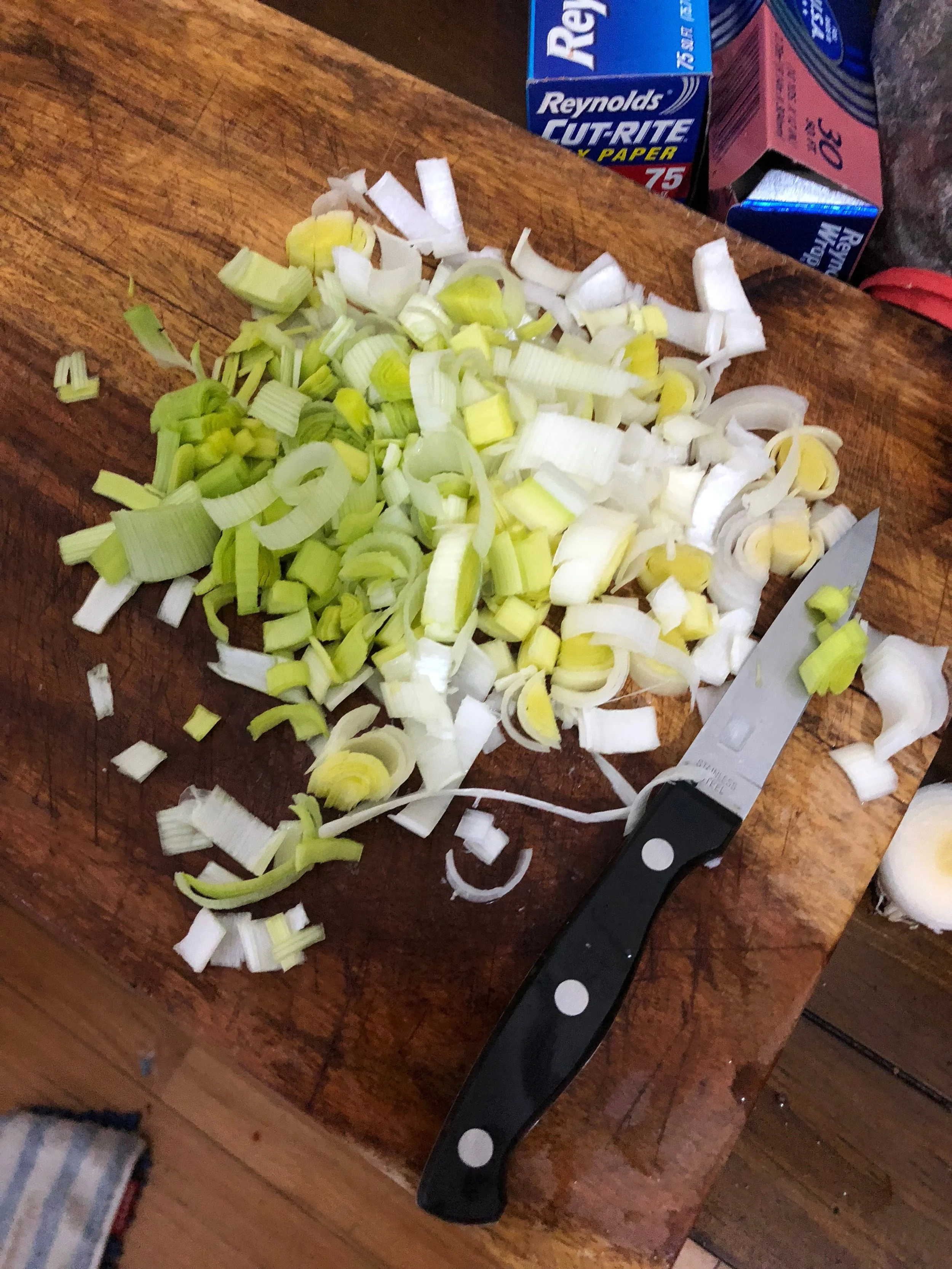 While the bacon is cooking, dice the leek and the garlic cloves. The core of the leek should be diced so it is in pieces. 