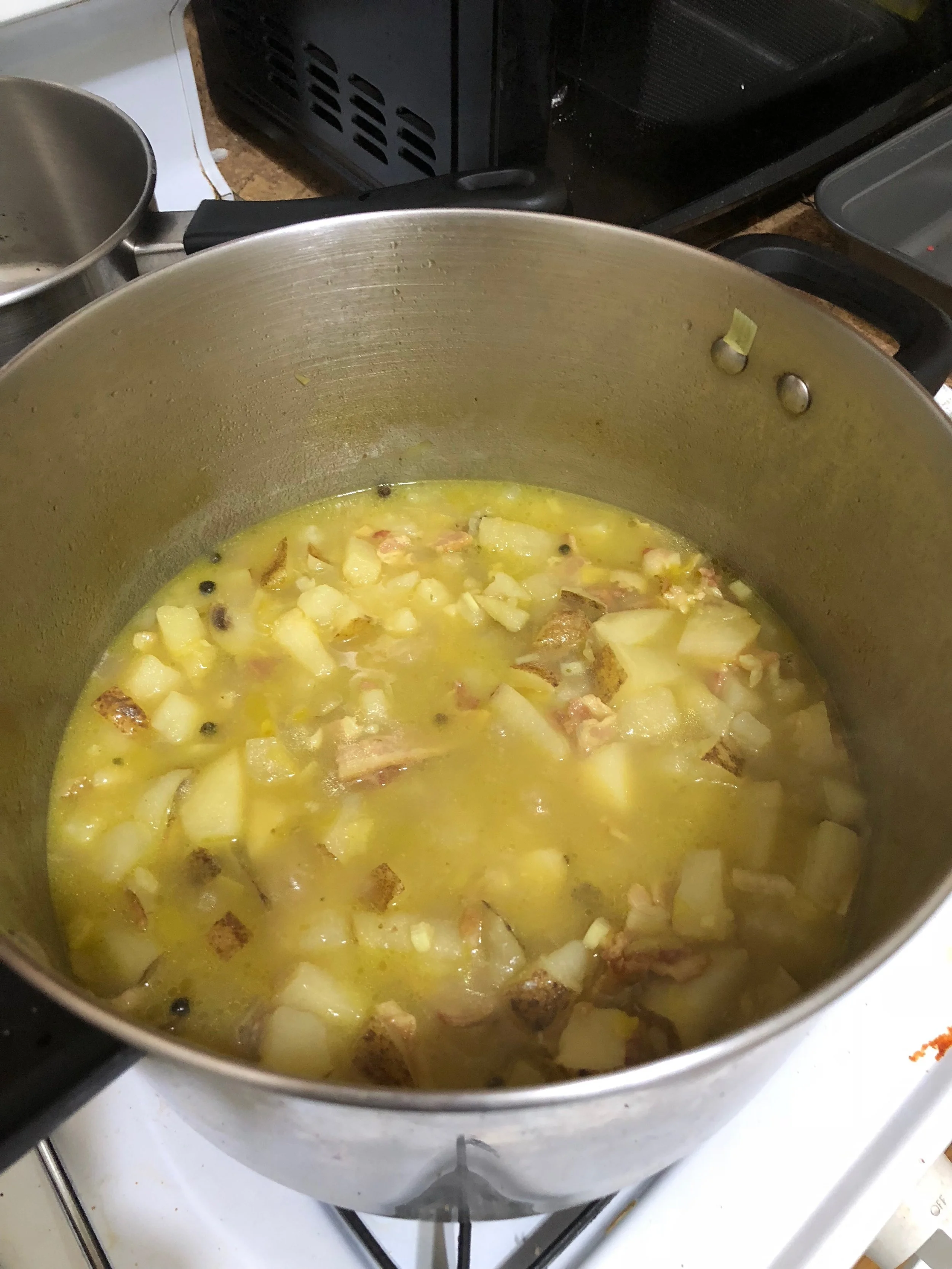 Add the chicken stock, butter and potatoes to the stockpot. Turn off the heat and let it soak for an hour (or more). After soaking, turn on medium heat, cover and bring to a boil. Cook the mixture until the potatoes are cooked thoroughly.