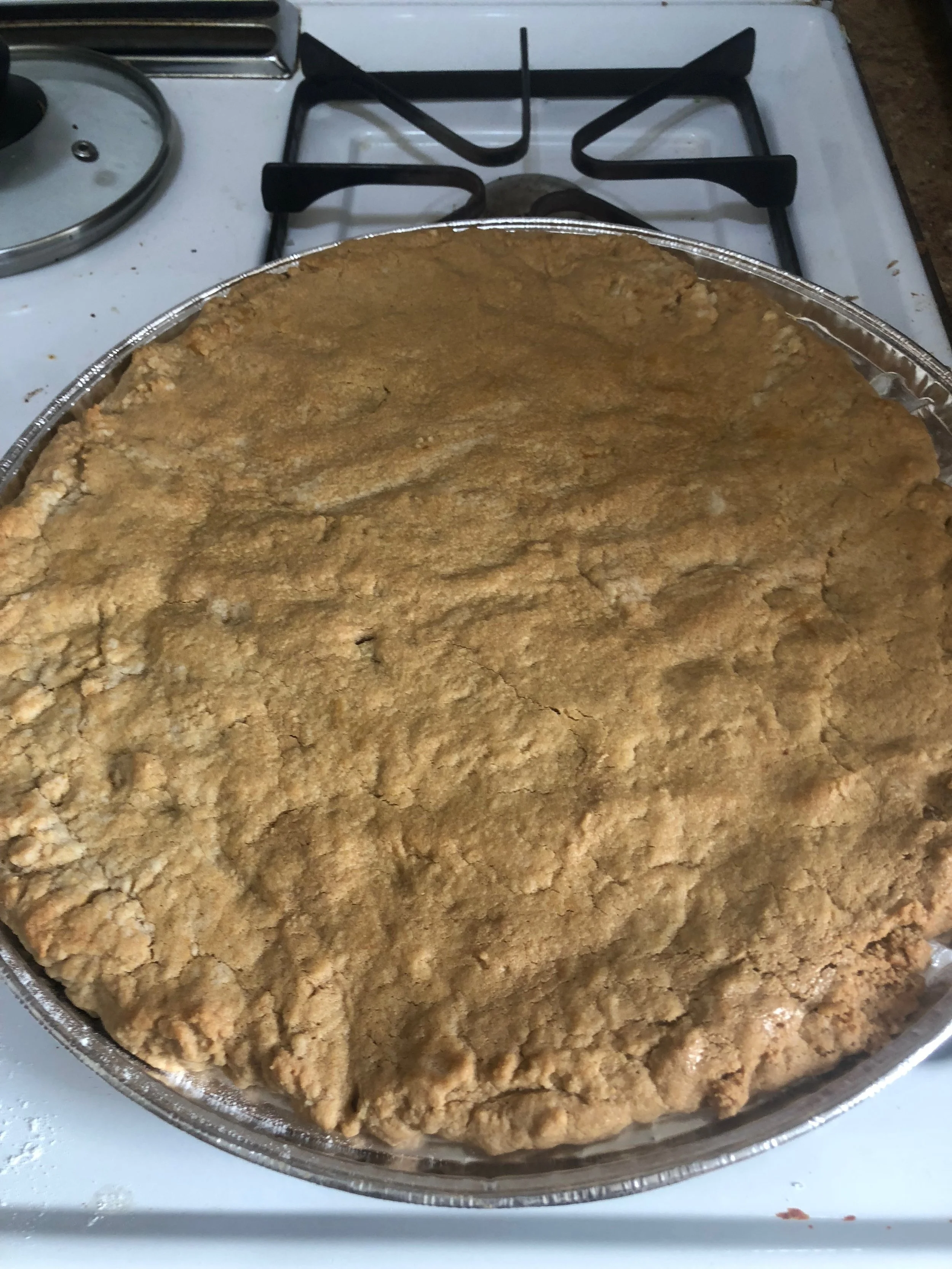 Remove cookie pizza from the oven and allow to cool after 9- 13 minutes (depending on your oven). When it is sufficiently cooled, (but still hot) place your Hershey kiss in the middle. Be prepared for it to melt! Word to the wise and a lesson I learned- don't put it on before it is cooled! I place my Hershey kiss on when it was still very hot...intially it looked like this: