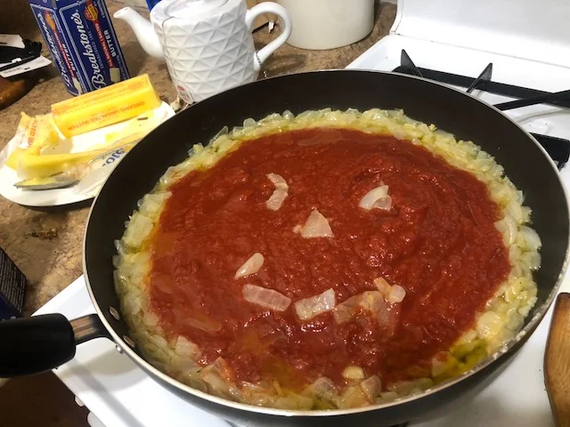 Get sauced while making sauce...and magic smiley faces magically appear in your pan! Stir contents and cook tomatoes for 30 minutes.