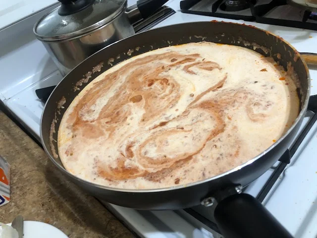 Add cream to sauce (testing to make sure the sauce is not so hot it'll curdle)