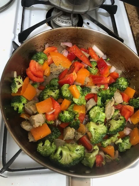 When sausage has acquired the savory crunchiness, add the vegetables and the remaining olive oil to the skillet. Cook on medium heat until the vegetables are cooked through. Put the mixture to the side to cool. If you're adding additional seasonings…
