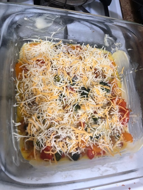 Cover the mixture with shredded cheese. I opted to use pre-shreded Mexican cheese blend I had in my fridge, but use whatever speaks to ya. In the recipe I read online it called for American cheese, so do whatever works! Then add the remaining eggs o…
