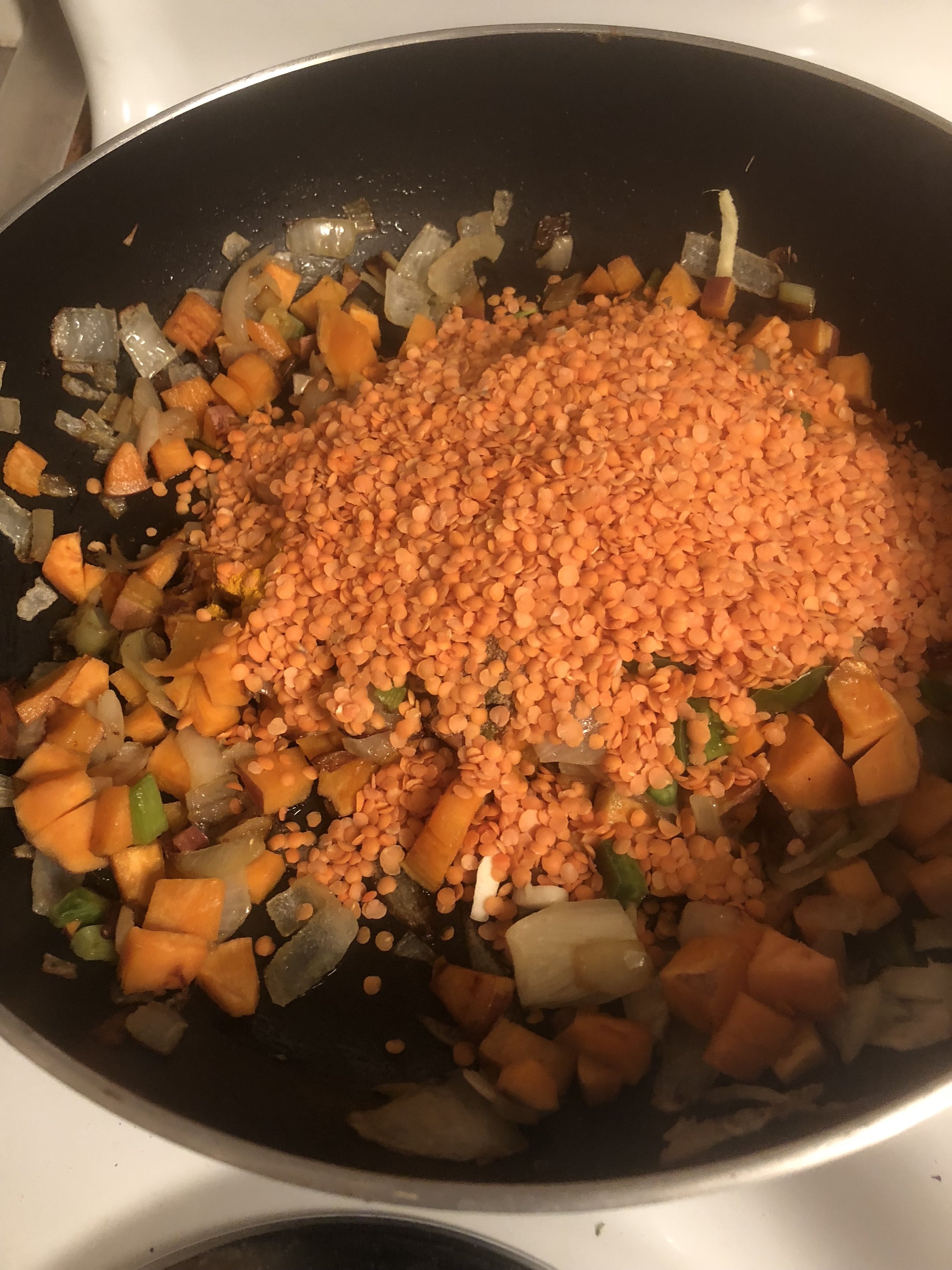 Add the lentils on top, stirring so all the lentils are coated with oil