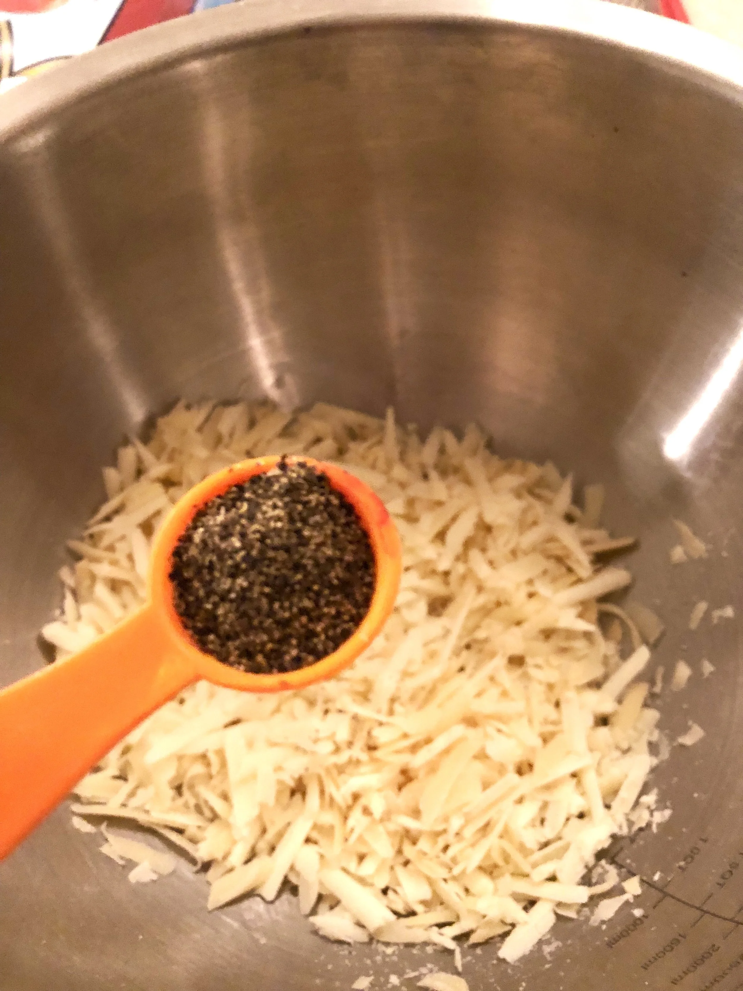 Measure your generous tablespoon of ground pepper, and add to the cheese. Mix everything together thoroughly. Add tbls of olive oil to the mixture.