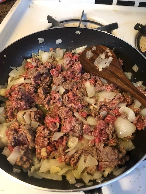 Add the meat to the skillet. Using whatever utensil makes sense in your kitchen, the stir the beef so it is evenly distributed and cooks evenly.