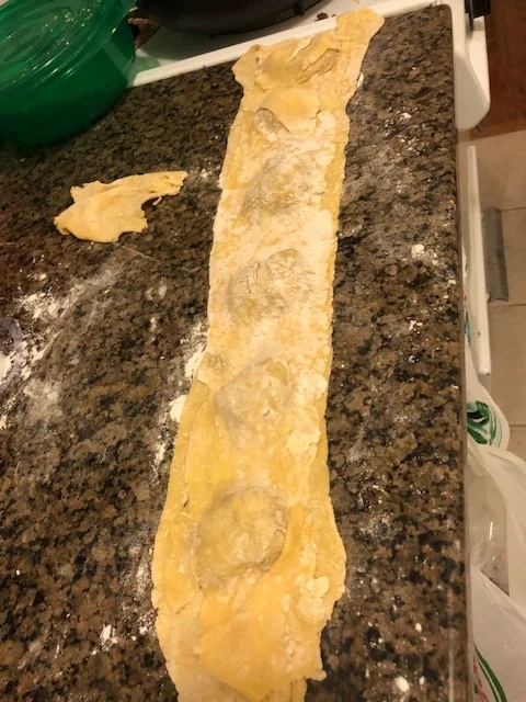 Using your sharp paring knife, make each ravioli into a square shape, taking care to leave sufficient space for each ravioli to have the meat sealed in. When the ravioli have been assembled, using your fork to press the edges of each ravioli to seal in the meat.
