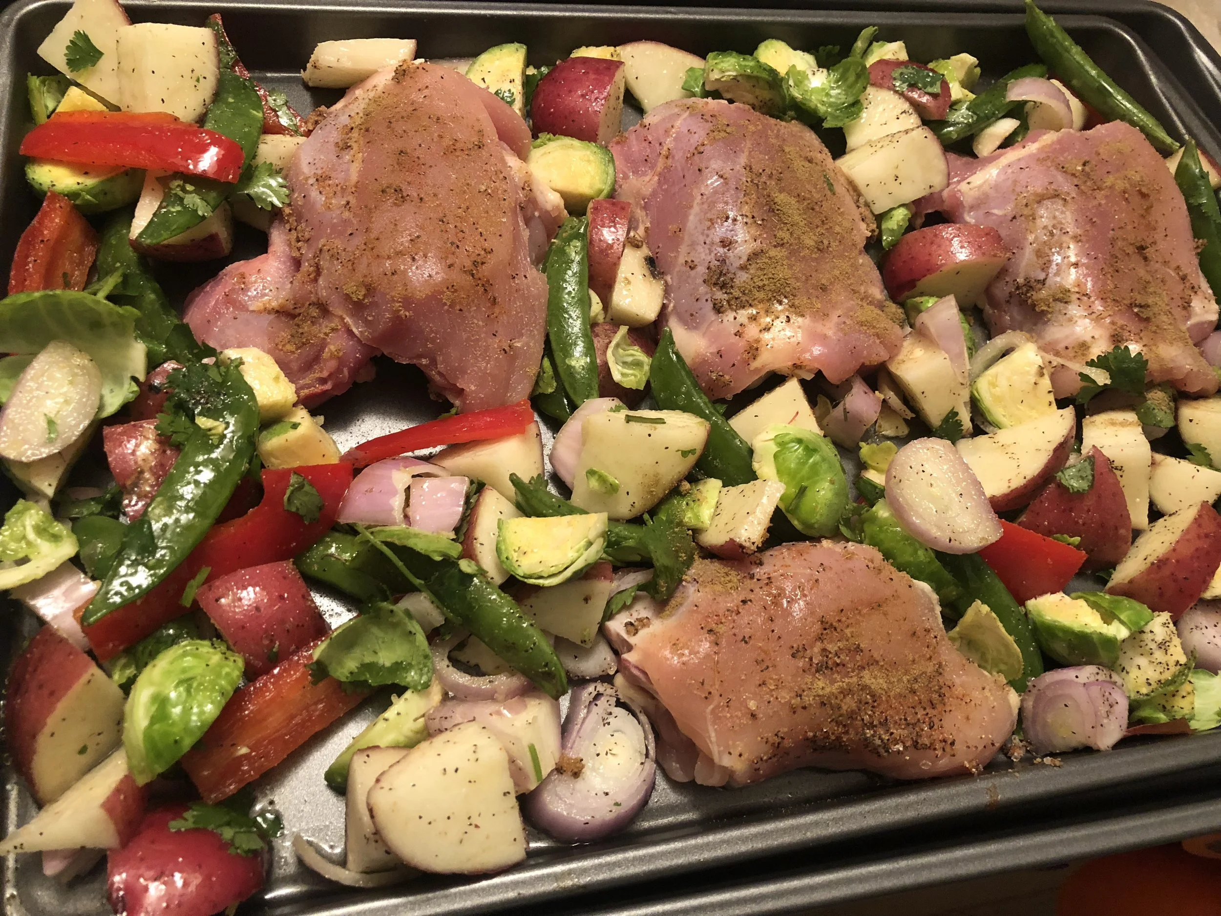 Arrange the vegetables around the chicken. Put in the oven for 15- 16 minutes. Remove at minute 17, turn vegetable over using your spatula, and then put back in the oven for char to happen on the vegetables and for the chicken to cook through. While…