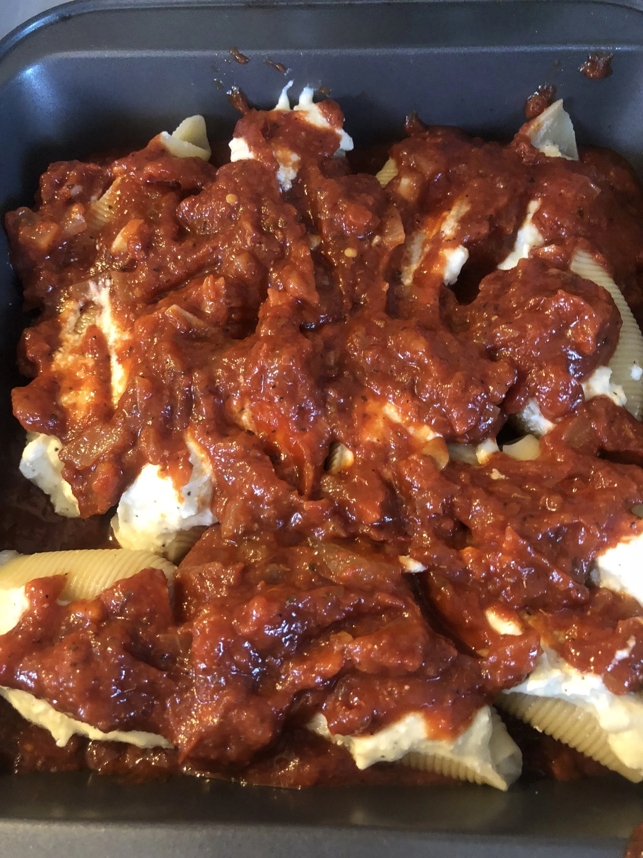 Cover the shells with the sauce remaining. Cover the top of the sauced shells with he mozzarella and place in the oven.