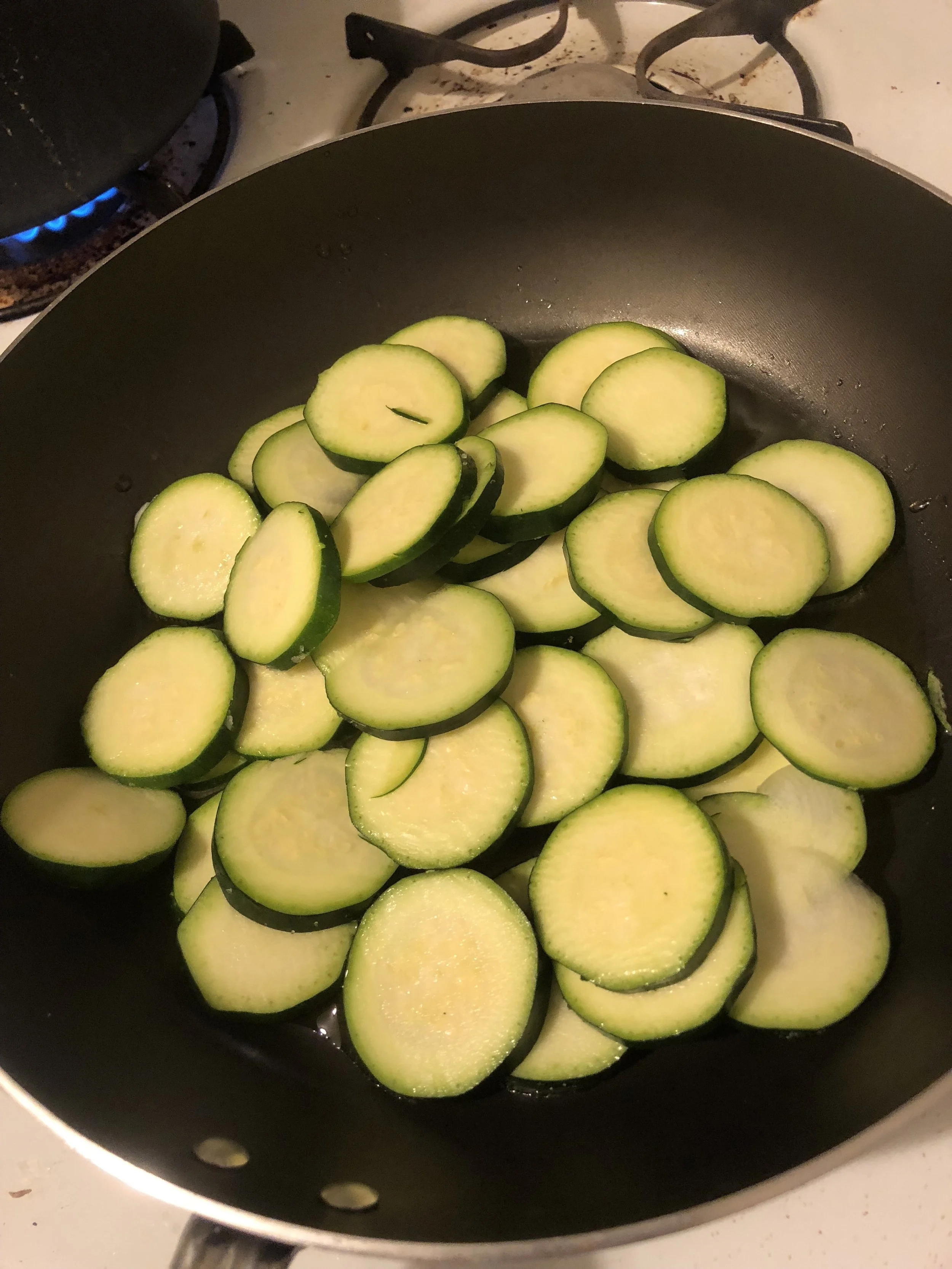 Heat Oil in your medium pan and cook until cooked through. While zucchini cooks, clean and dice the red bell peppers into bite sized pieces.