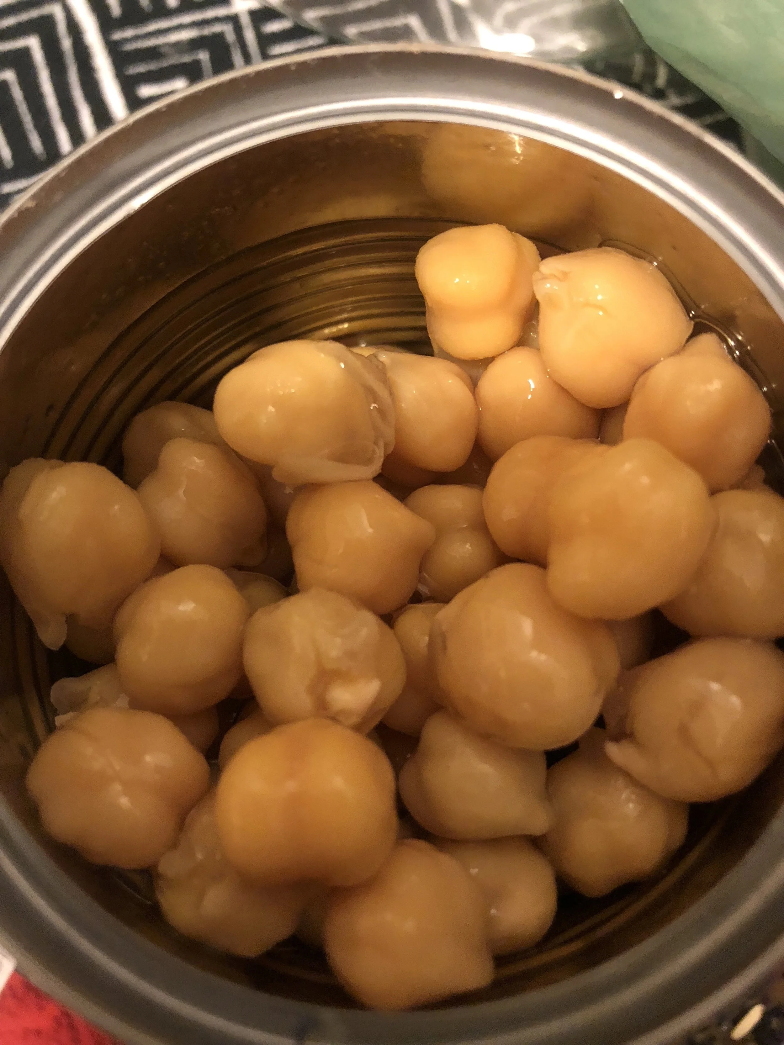 Open your garbanzo beans, drain and pour apx 0.5 of the can into the pan.Add pineapple pieces, and stir. Taste the sauce, and add salt, pepper, and crushed red pepper as needed, according to your preferences!