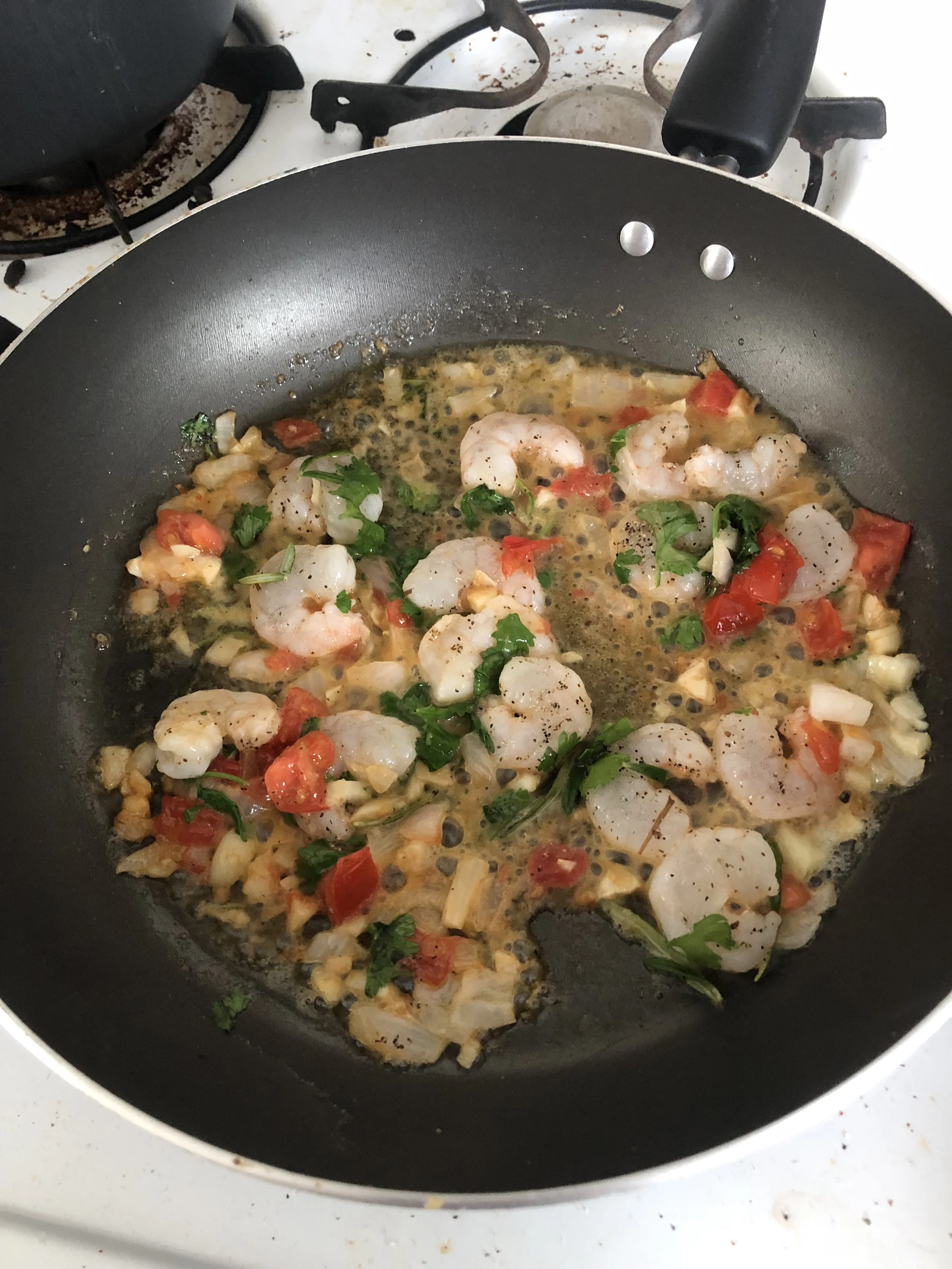 Add the butter, garlic, tomato and onion into the medium frying pan. Take the leaves off the Rosemary, crush between your fingers and then toss the shrimp with salt, pepper, and rosemary.&nbsp;When aromatic, add the shrimp to the frying pan and cook…