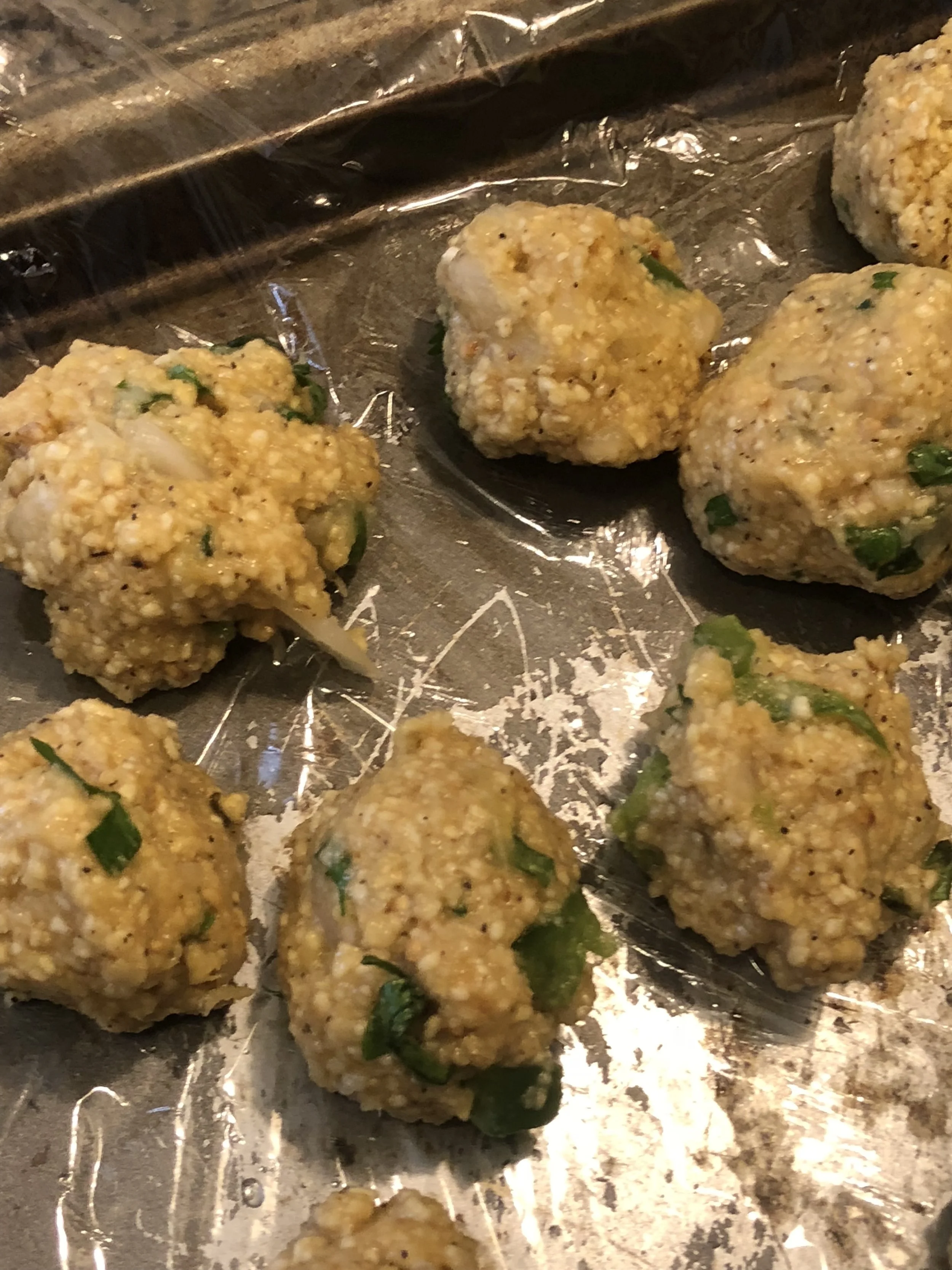 Wet your hands and cover your baking sheet in plastic wrap. Using wet hands, form matzo balls from about a tsp to tbs sized matzo balls.