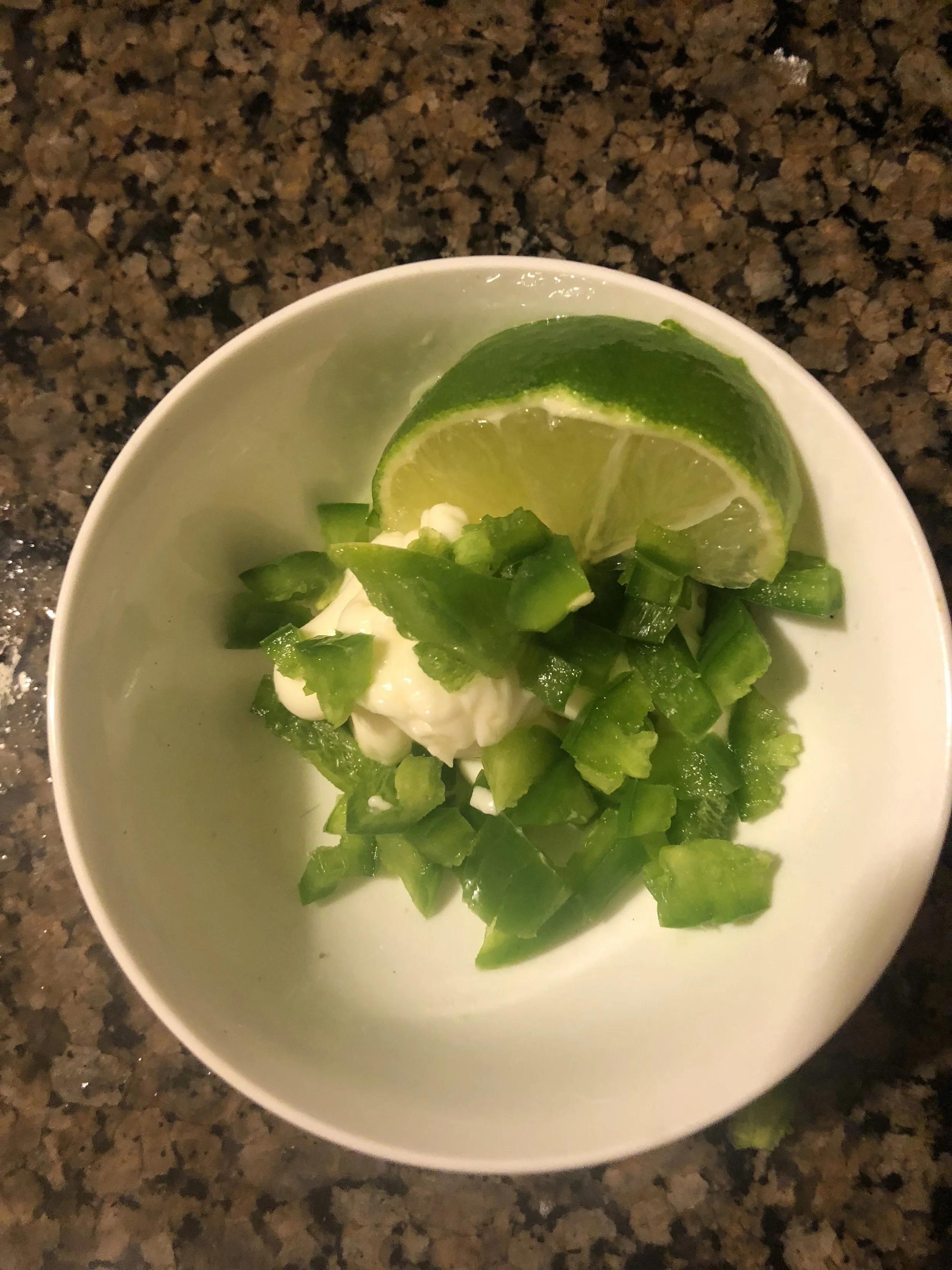 For the Jalapeño aioli, place your mayonnaise base, diced jalapeños, diced garlic, chopped cilantro and lime juice. Mix throughly