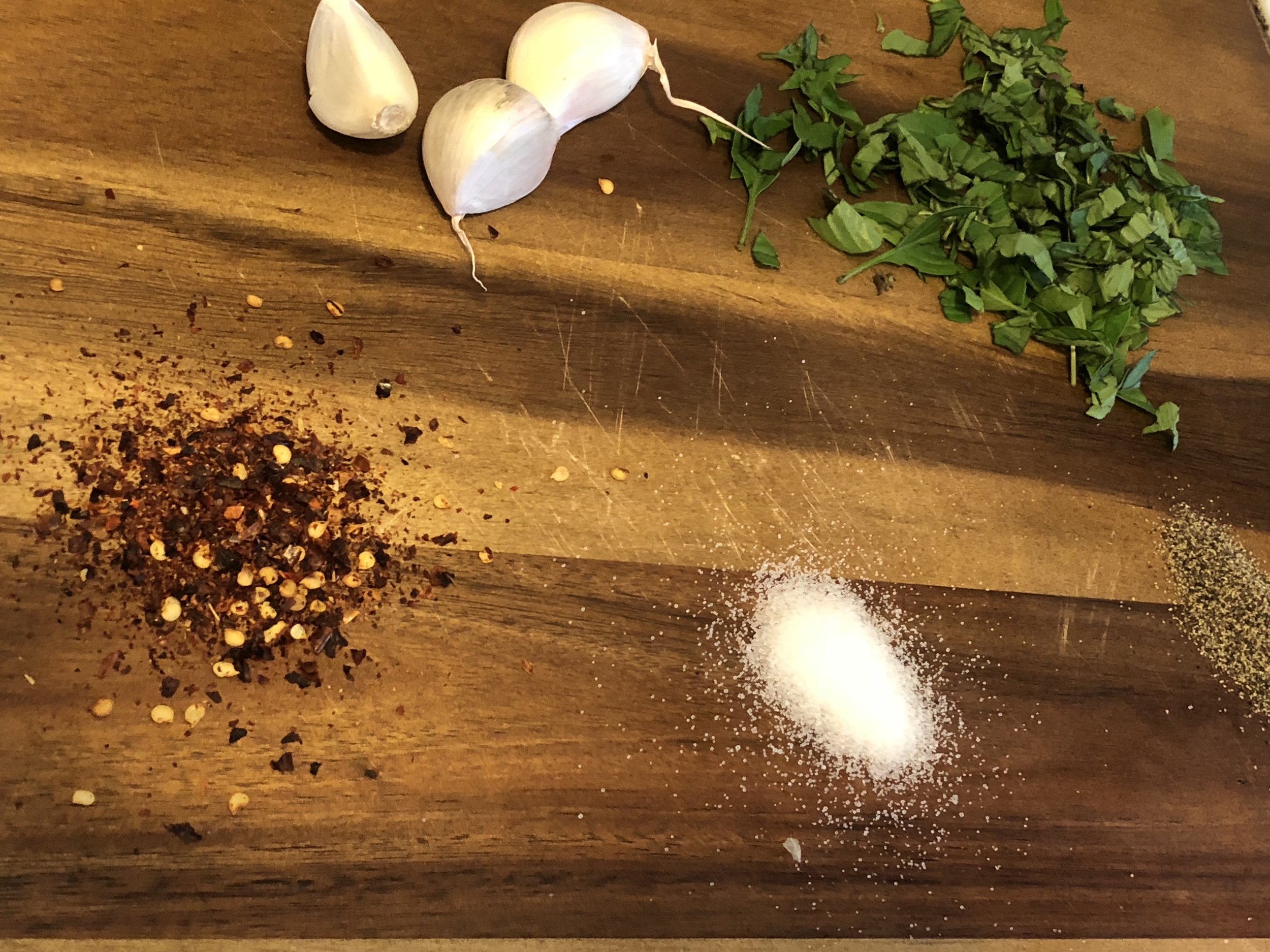 Ingredients tsp of salt (or so) tsp of ground pepper) cup of Thai basil leaves tbls of red pepper flakes 2-3 medium cloves of garlic (5-6 sm cloves) 3 tbs of olive oil tbls of honey (or your preferred sweetening syrup) tsp (or so) of soy sauce tbls of rice wine vinegar Dice your Thai basil leaves and garlic cloves. Combine all the ingredients thoroughly - you could use your food processor, but I didn’t.