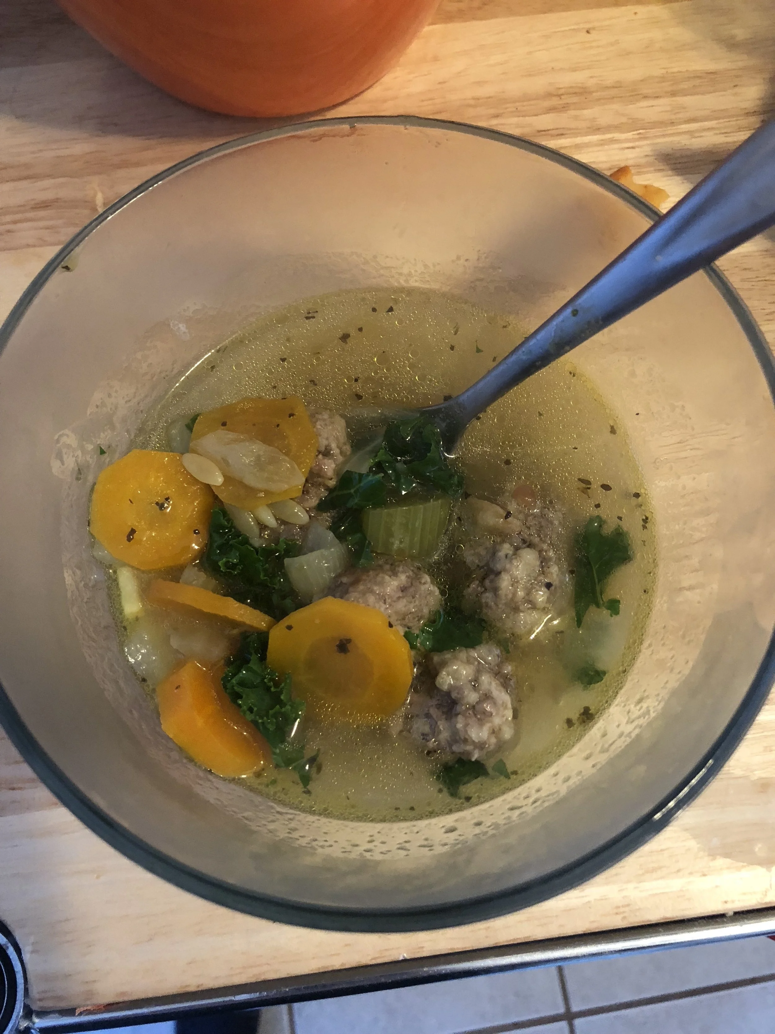 Ingredients MEatballs 0.80 oz of ground pork 0.80 ox of ground beef Italian seasoning 5 slices of Asiago bread an egg powdered garlic Soup 9 cups of chicken stock 5-6 cloves of garlic medium yellow onion 3 medium carrots 2-3 medium stalks of celery cup of kale (finely chopped) 2 bay leaves powdered garlic ground pepper sea salt cup of orzo pasta