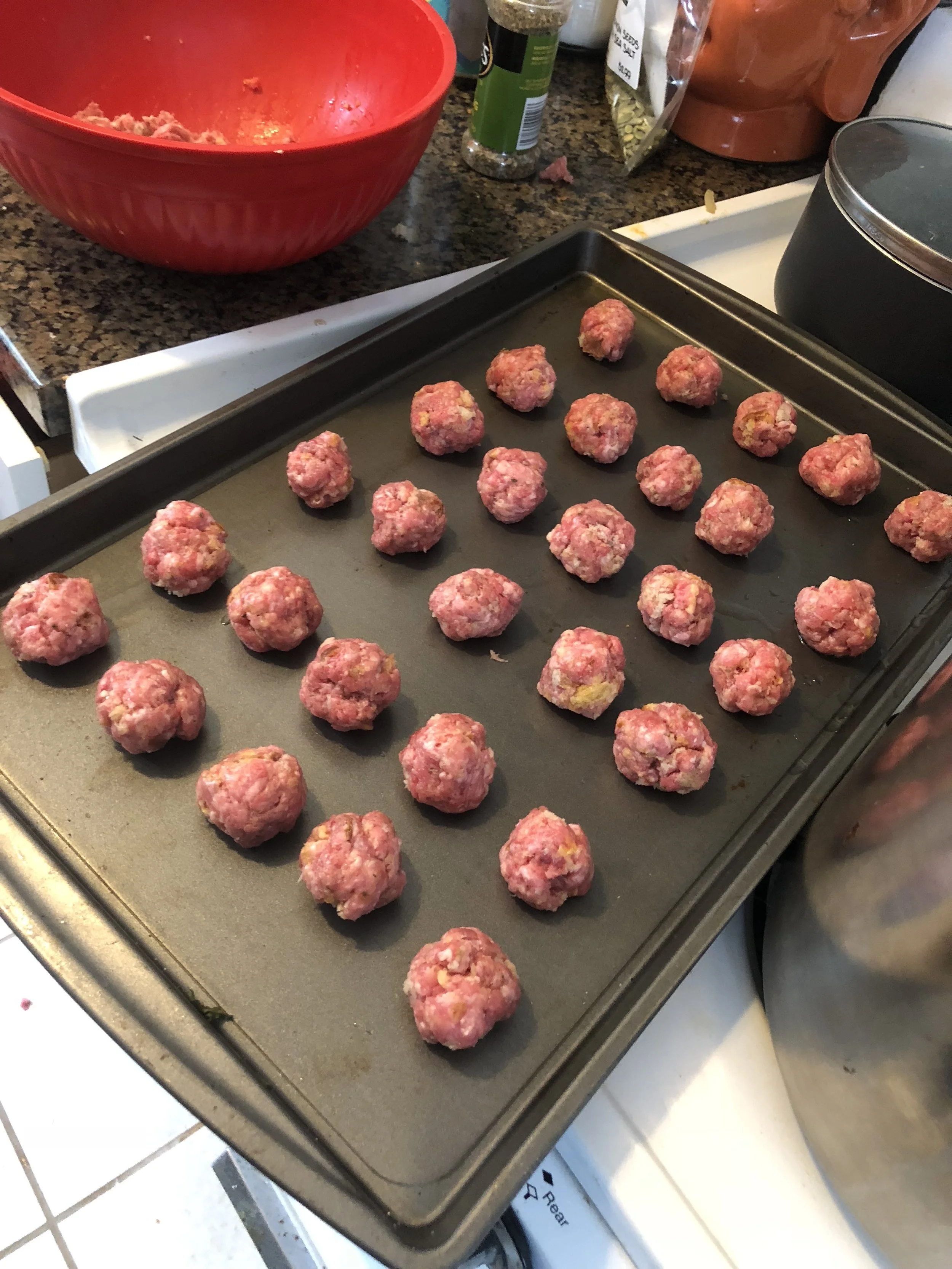 Using your hands, make tiny meatballs, using apx tsp of meat for each meatball. Set out a baking sheet to place the meatballs in an organized fashion.