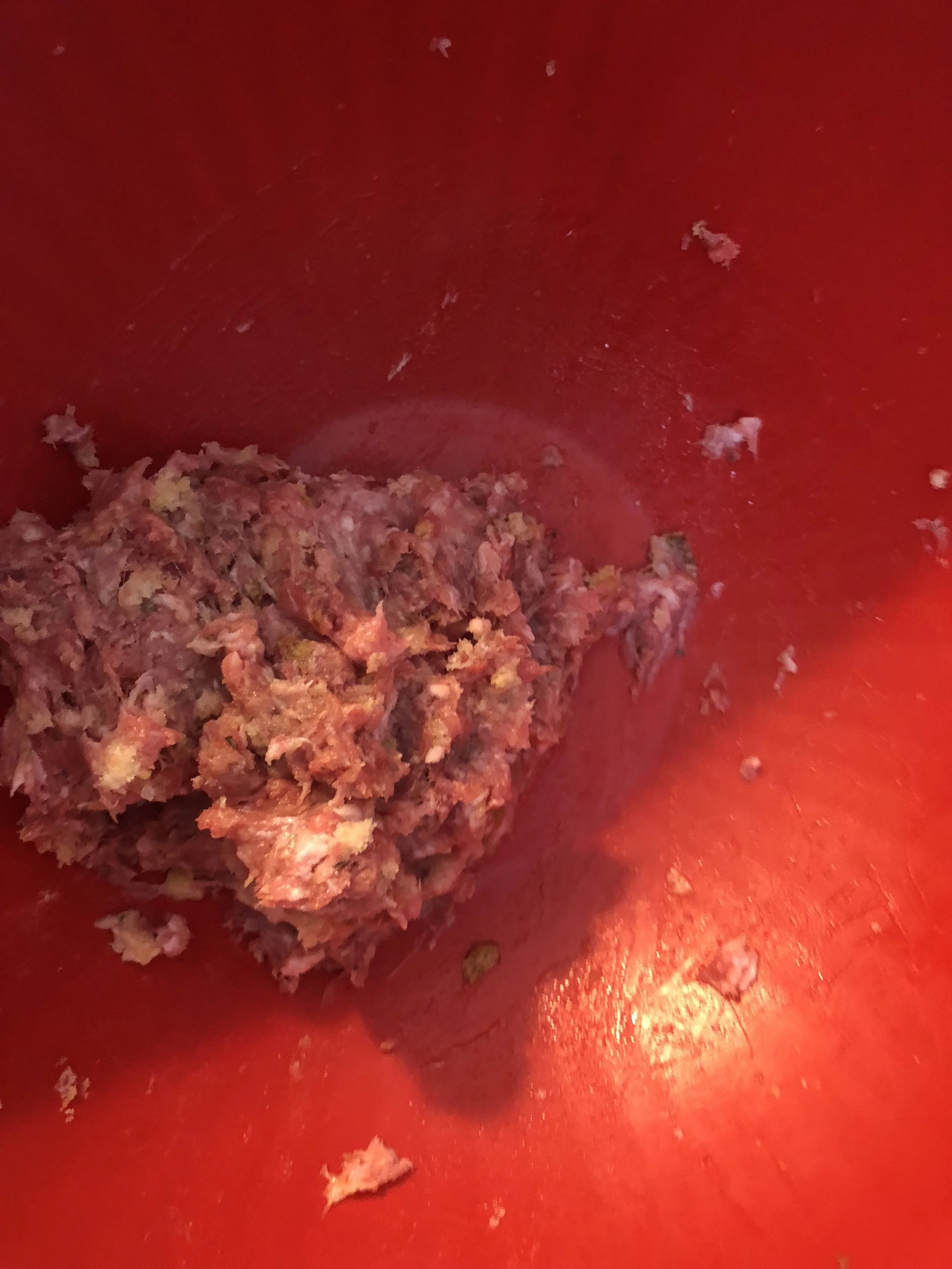 Add a cup of the Asiago bread crumbs, the beef, pork and egg into your mixing bowl.Knead with your hands until everything is combined and then season with Italian seasoning and garlic.
